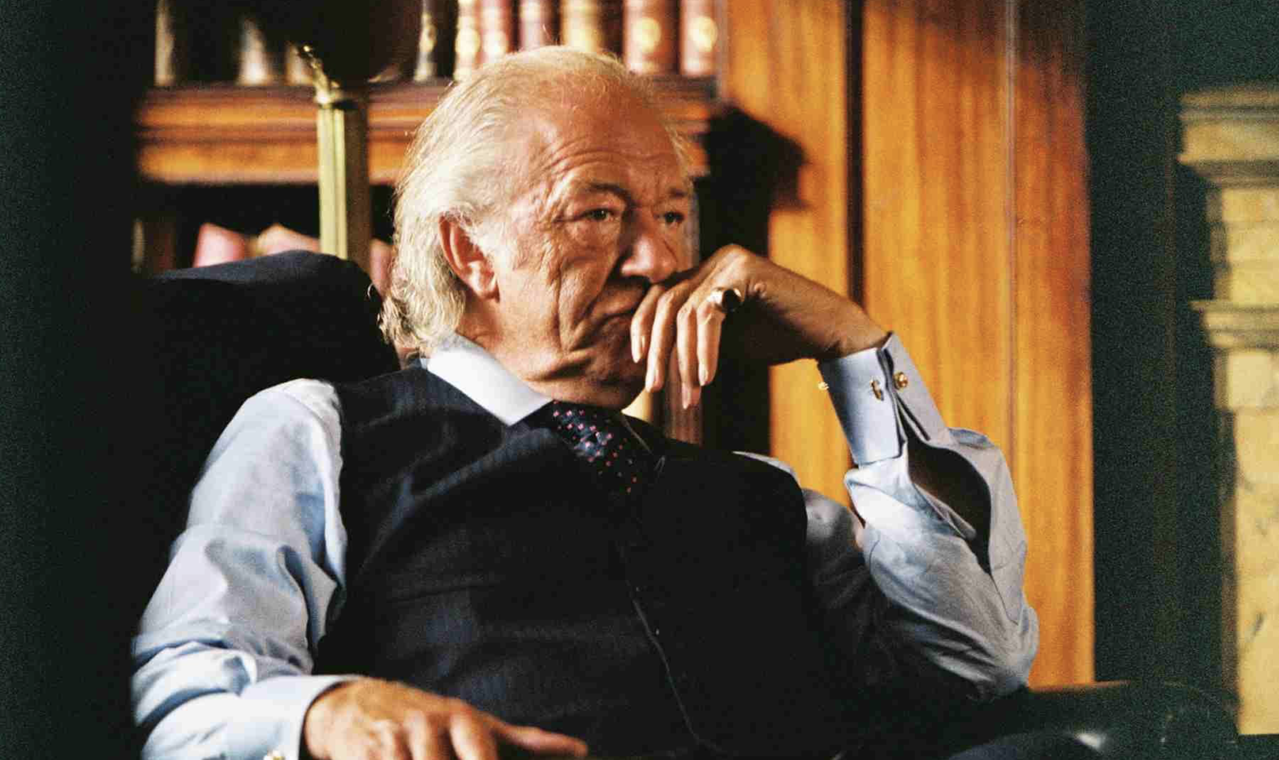 Michael Gambon as Eddie Temple in the film Layer Cake (2004). Depicts an older man dressed formally  a waistcoat, reclining in a chair.