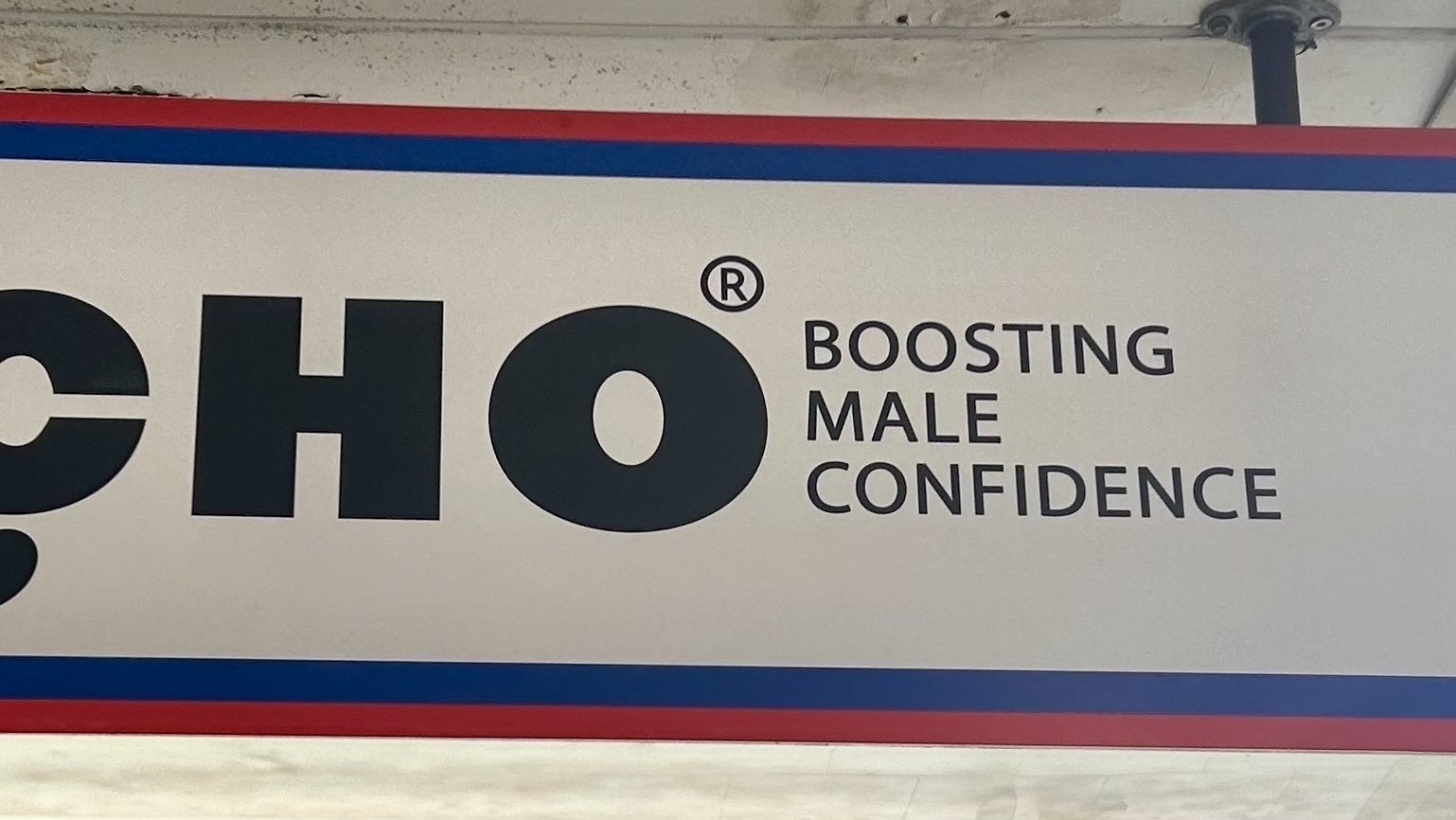 A store sign that includes the tagline: Boosting Male Confidence. 