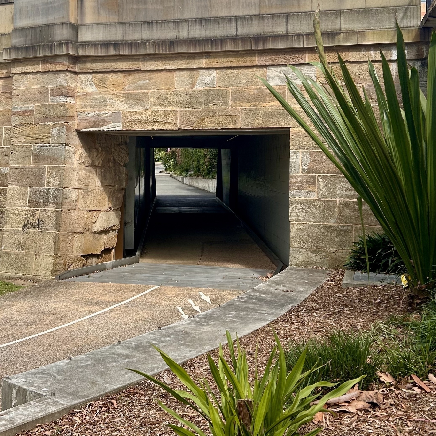 The Lennox Street Bridge pedestrian underpass in Parramatta. It's a shaded tunnel in a sandstone bridge. 