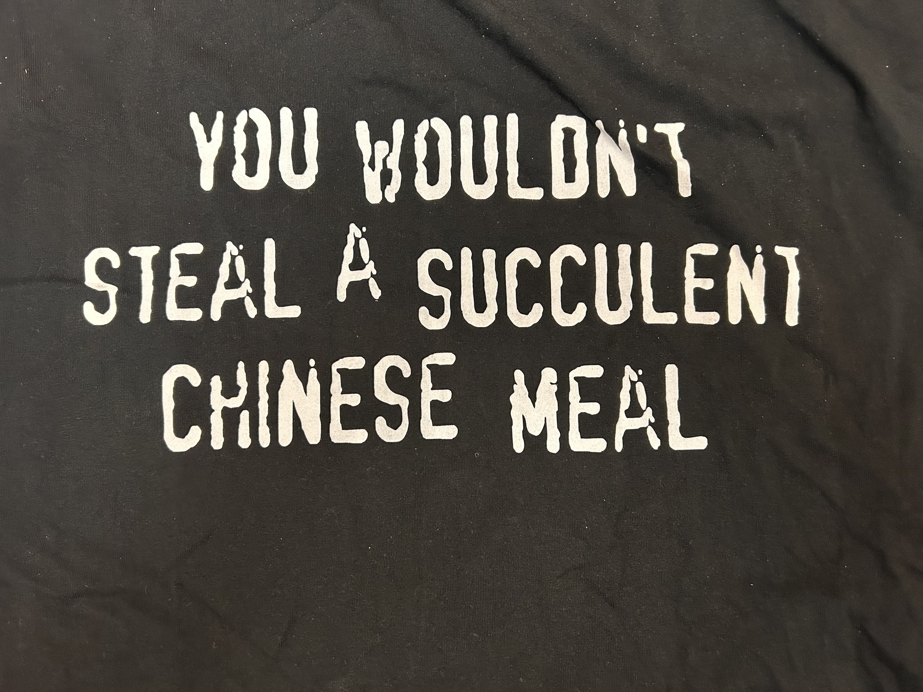 White text saying "you wouldn't steal a succulent Chinese meal", which refers to both the Democracy Manifest meme and the copyright warning ad that used to be on DVDs and VHS tapes.  