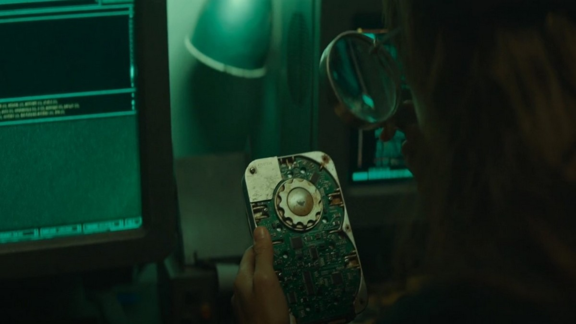 A hand holding an aged, odd looking hard drive. It's from the TV series Silo, which is set several hundred years in the future after a civilisational collapse. 