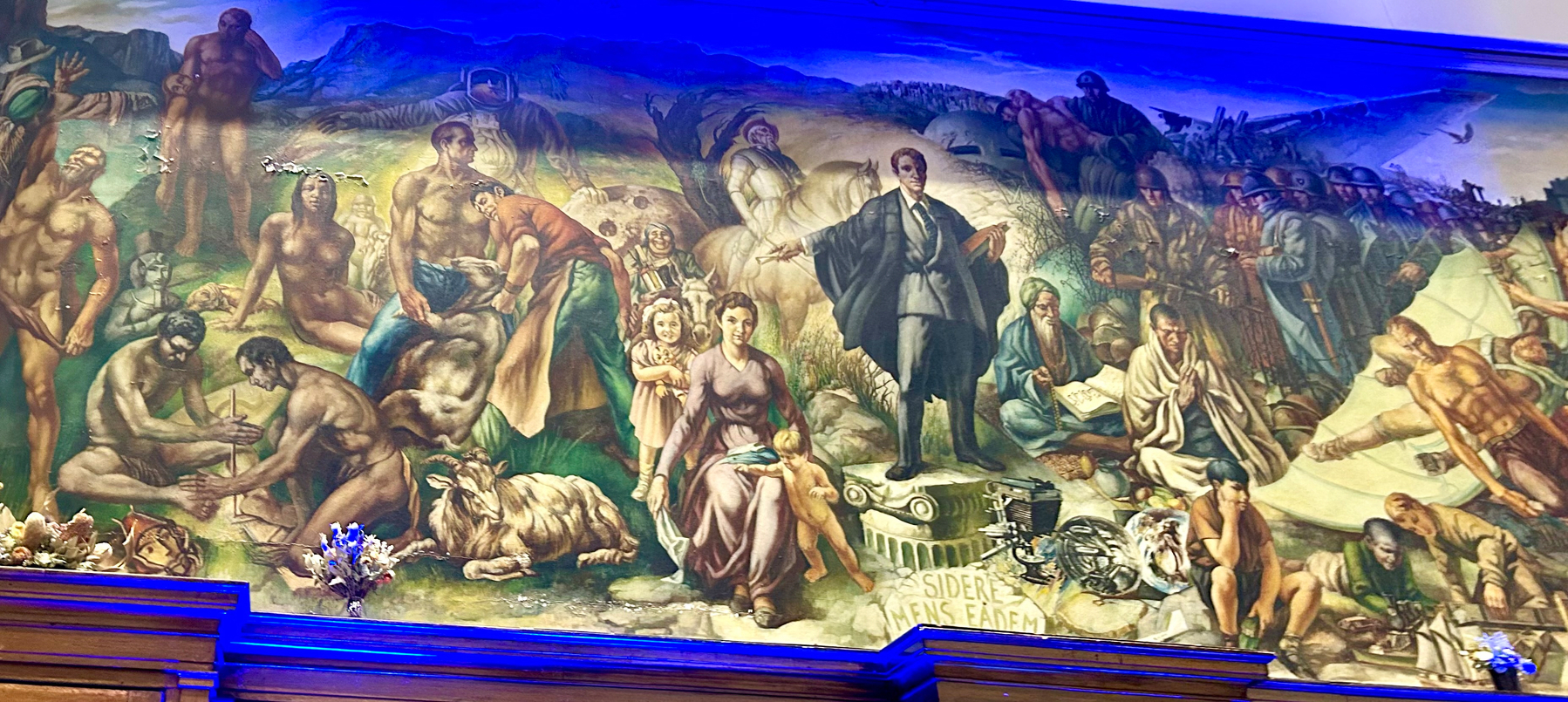 A detailed mural depicts various historical Australian and allegorical figures, with a central, illuminated academic gown-clad man standing on a pedestal surrounded by others. I won’t describe it all because the colonialism, classism and sexism is a lot. 