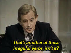 A person in a suit is speaking with the caption: That's another of those irregular verbs, isn't it? it’s the character Bernard Wooley from the TV show Yes Minister. 