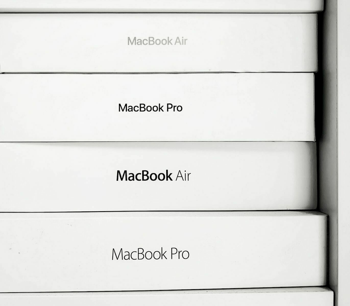 A stack of MacBook Air and MacBook Pro boxes, label out.