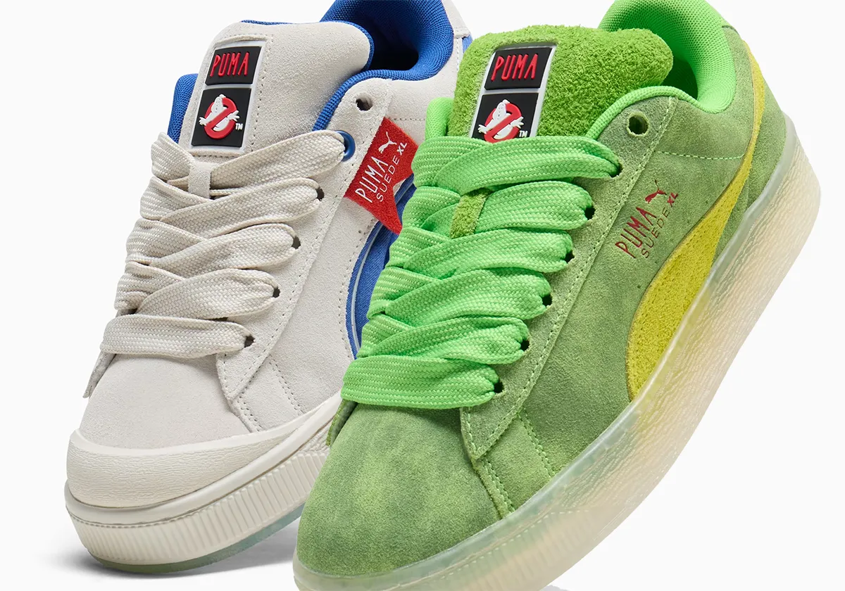 A pair of Puma sneakers featuring Ghostbusters-themed designs, with one shoe in white and blue and the other in green and yellow.