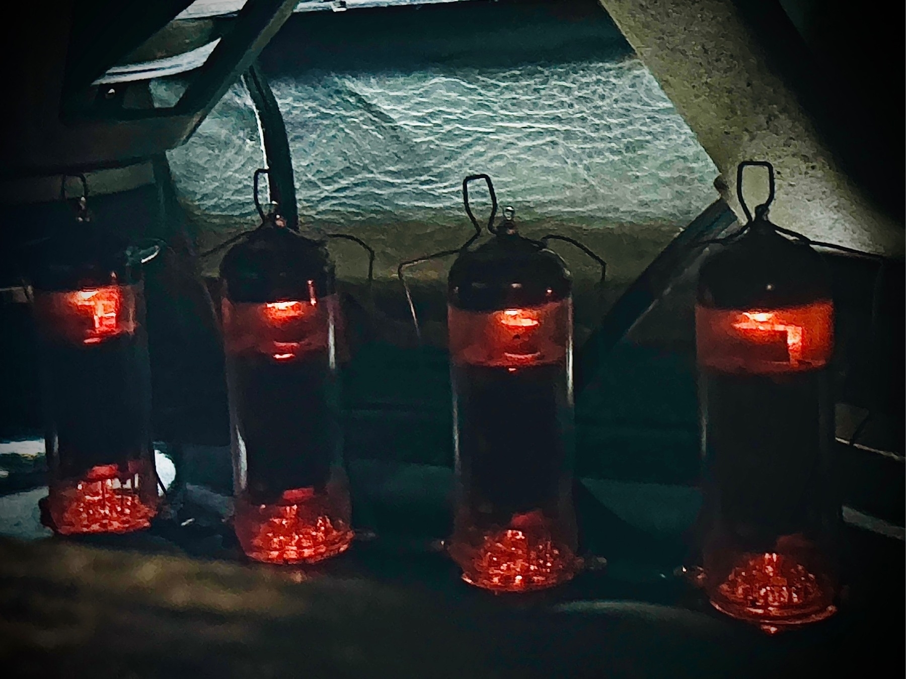 Looking down through the vent opening on the top of a tube amplifier, four vacuum tubes glow red hot.