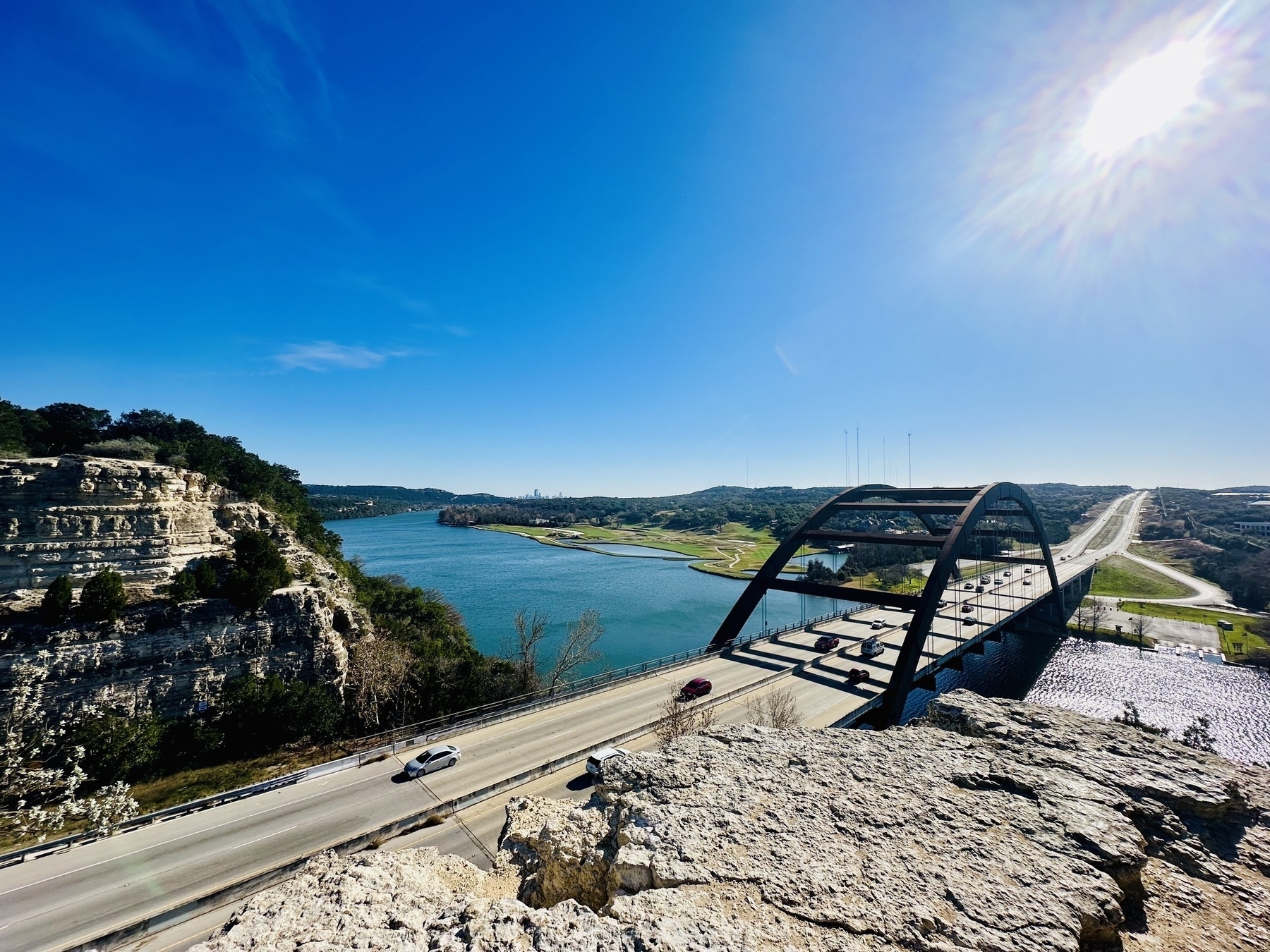 A view of the Pennybacker (360) Brdige from atop the surrounding bluff, looking out over the river and surrounds.