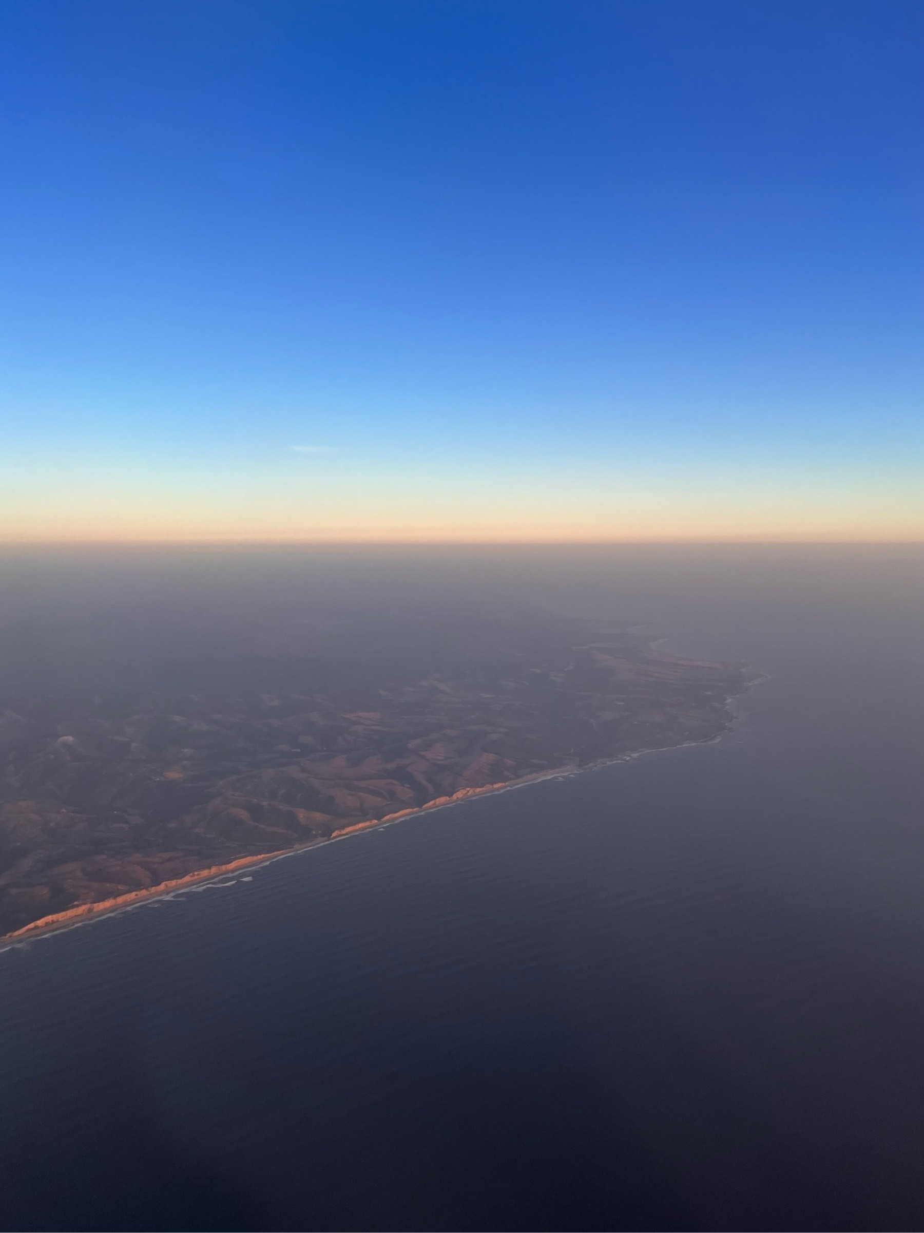 Looking towards the horizon as I approach and see the US west coast, just south of San Francisco, flying in from Maui