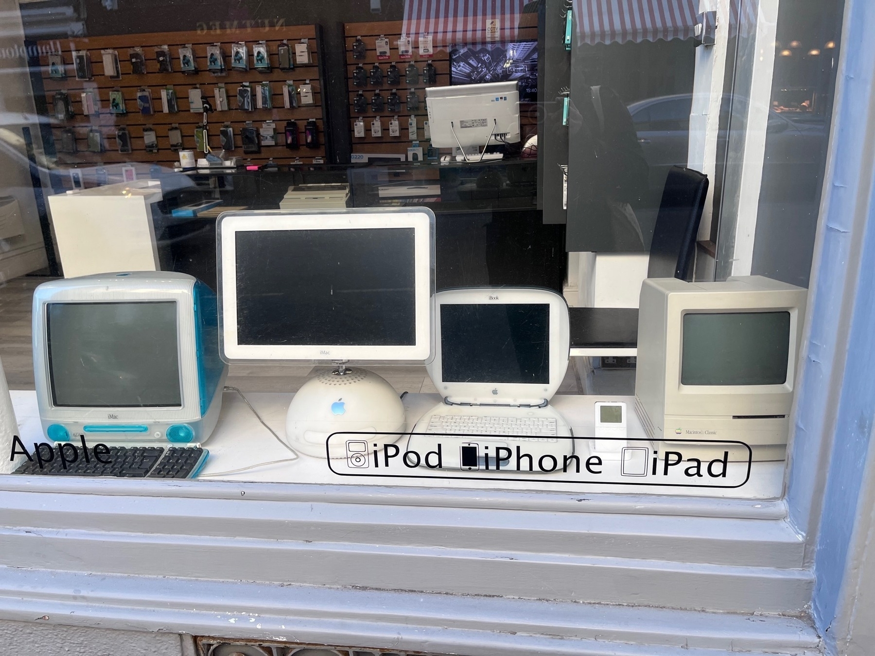 Old Apple computers and iPod in a shop window