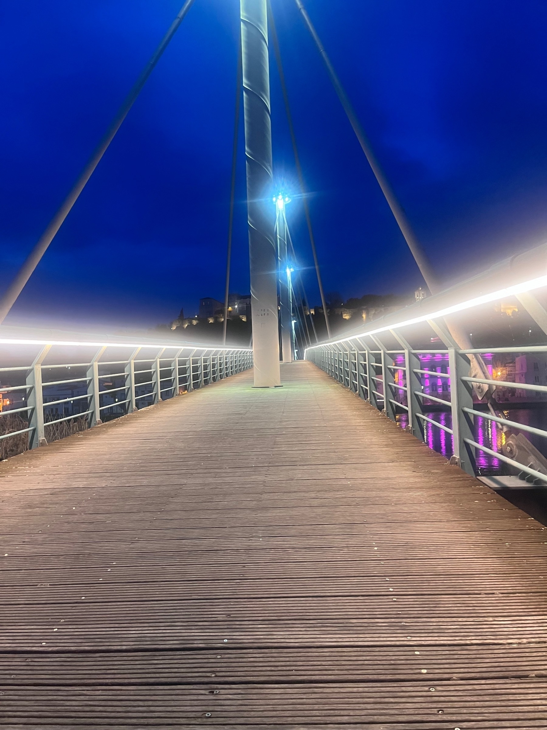 Foot bridge over the River Sado lit up at night