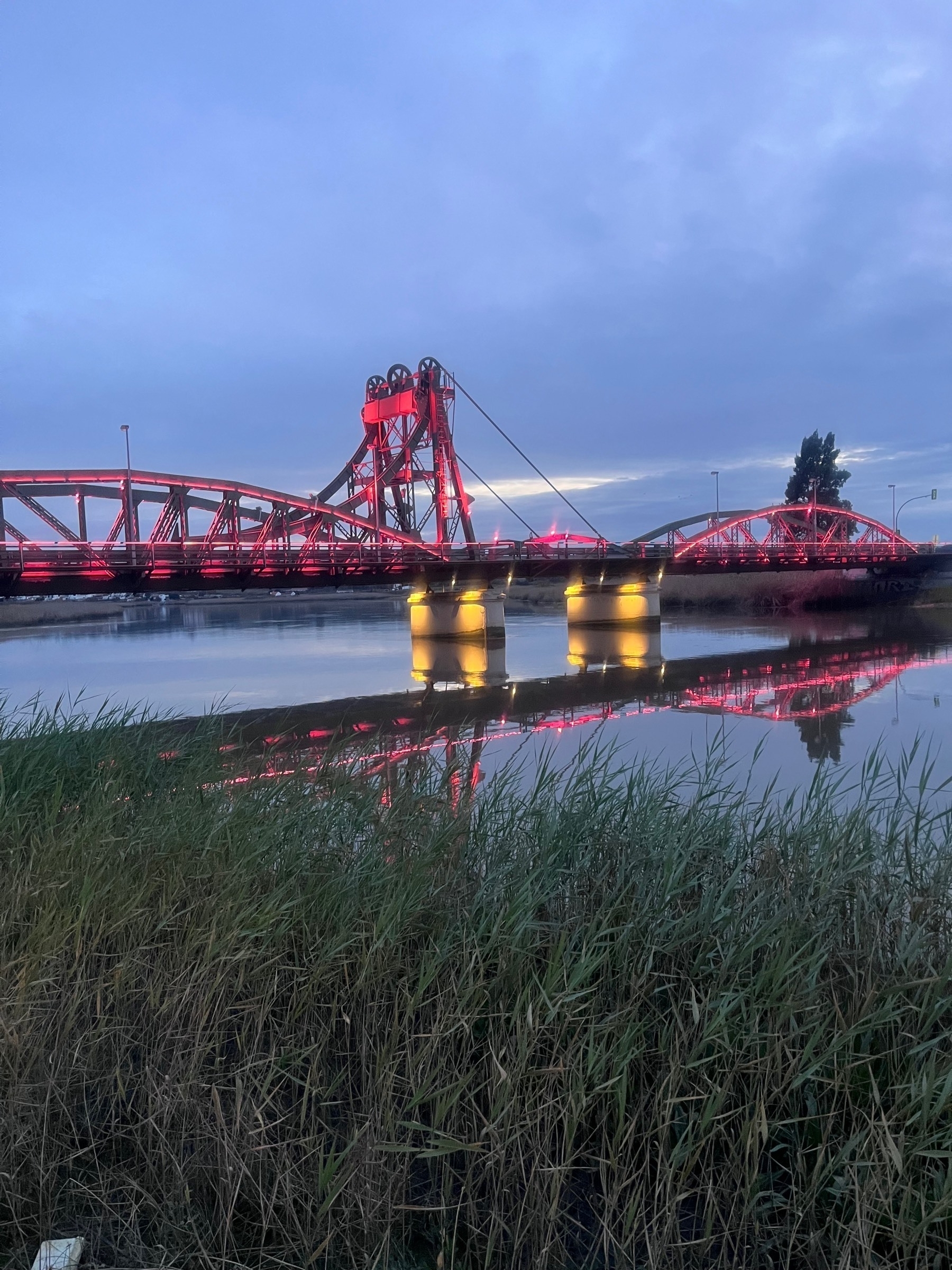 Bridge over the River Sado lit up with red lights