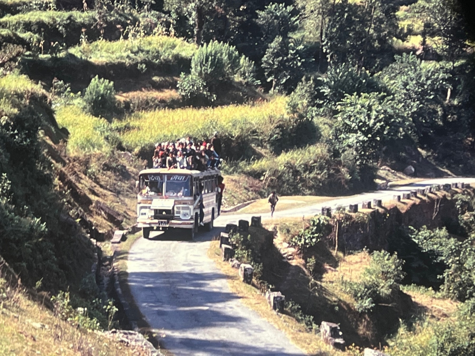 Bus with a lot of people sitting on the roof, somewhere in Nepal in 1989