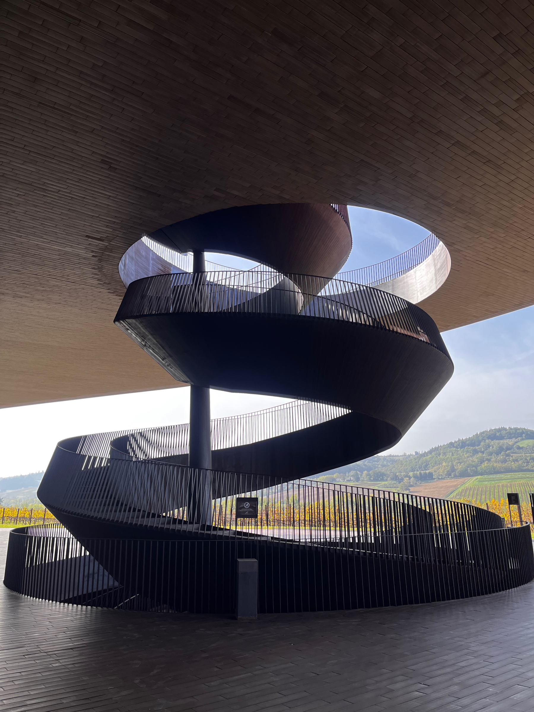 A spiral staircase winding its way up through the floors, outside at Antinori nel Chianti Classico, a winery in Tuscany, Italy