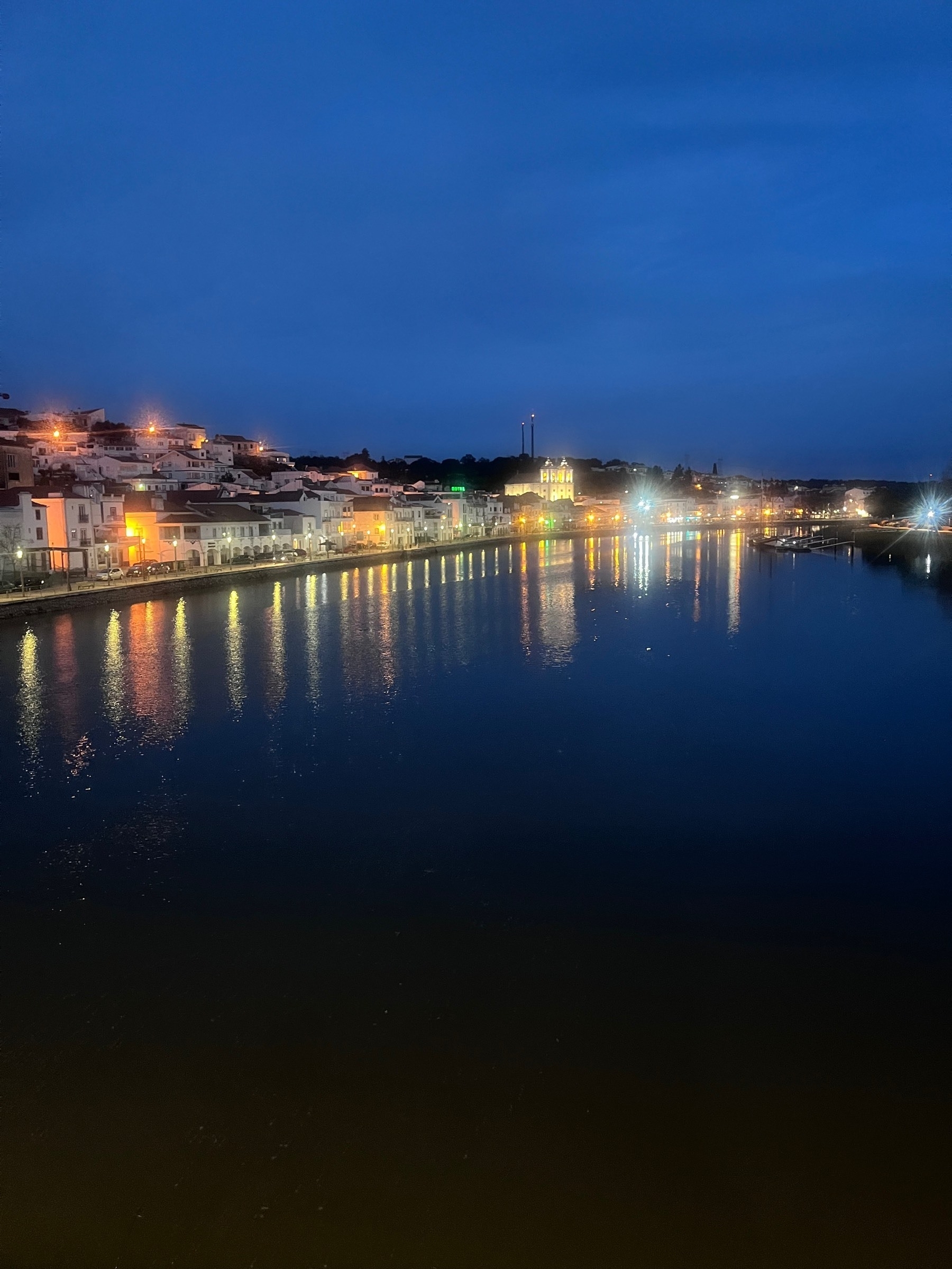 Alcácer do Sal by night from foot bridge over the River Sado