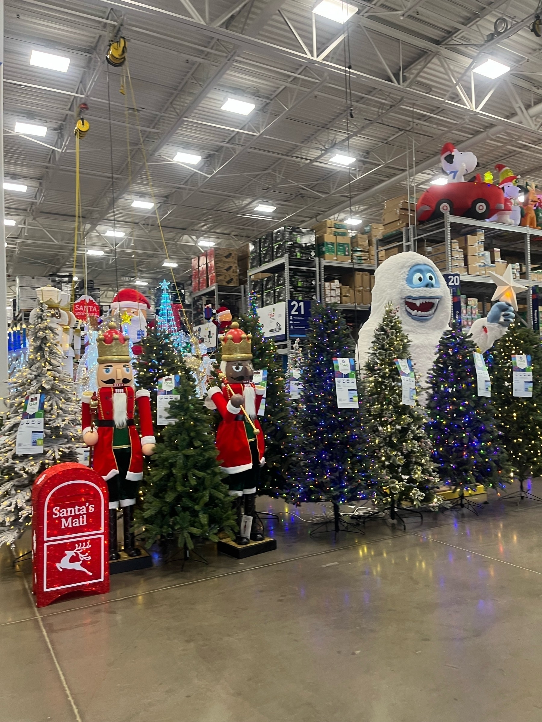 Christmas decorations, including large figures and artificial Christmas trees greet shoppers as they enter a store in September.