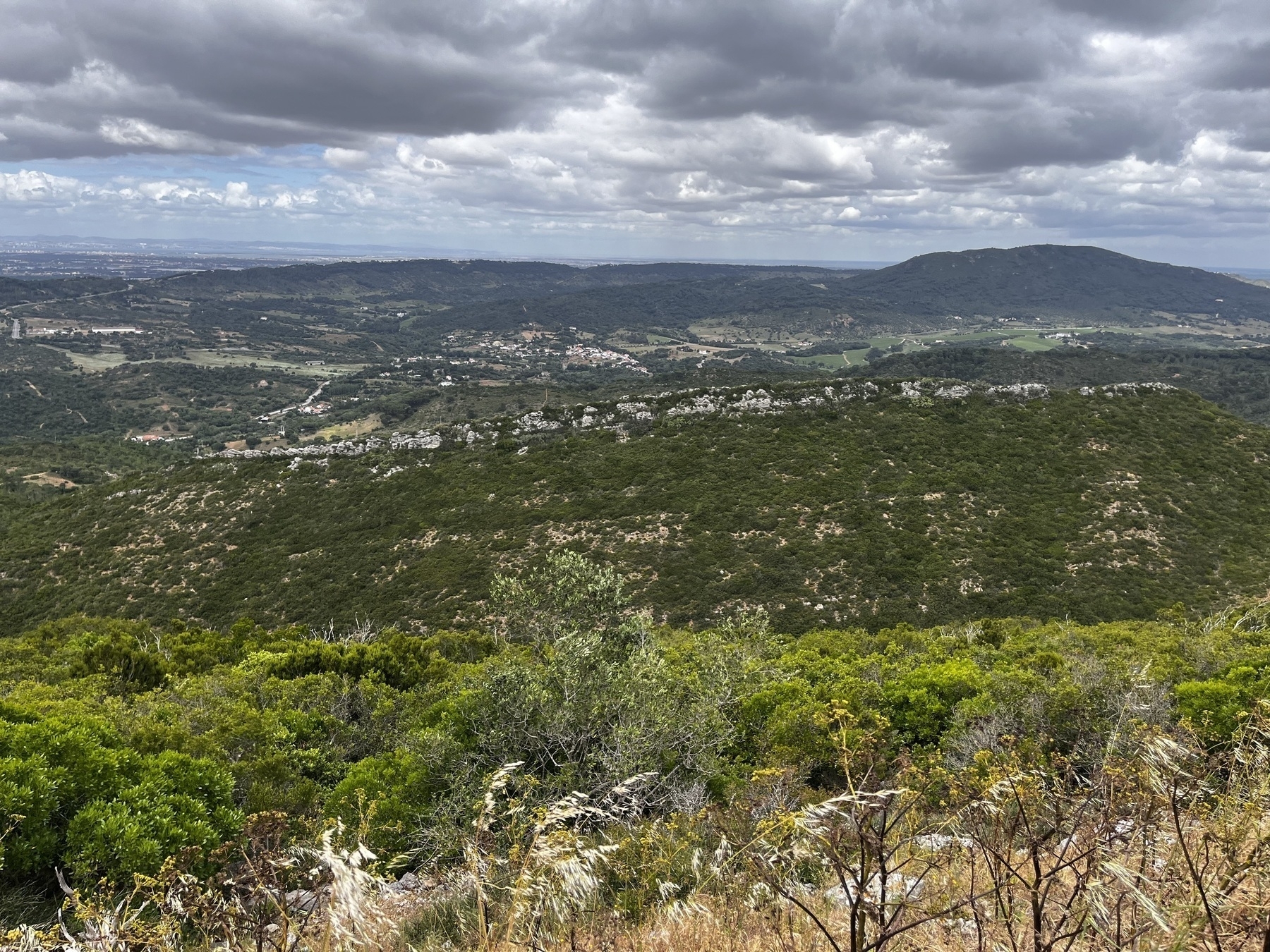 Low cloud hangs over a landscape of hills and stone