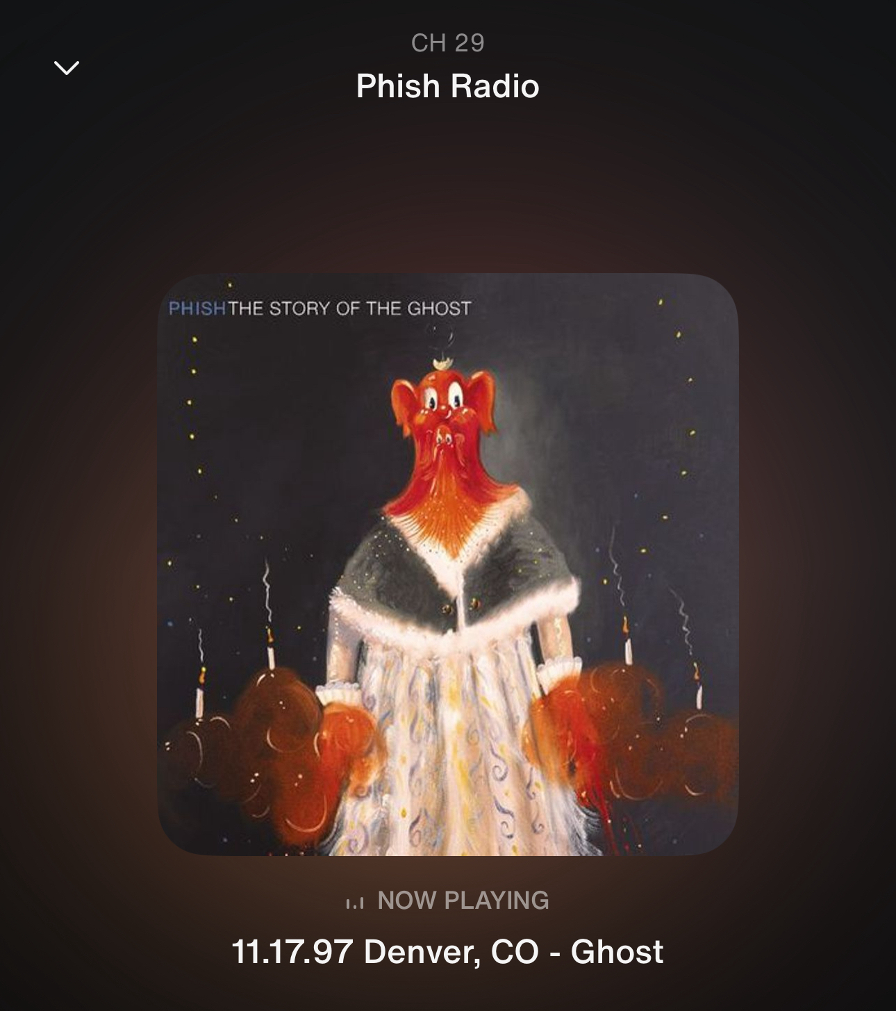 Digital display of a music player tuned to Phish Radio, showing the album cover art for “Phish: The Story of the Ghost.” The art features an abstract painting of a red ghostly figure in a white gown against a dark background.