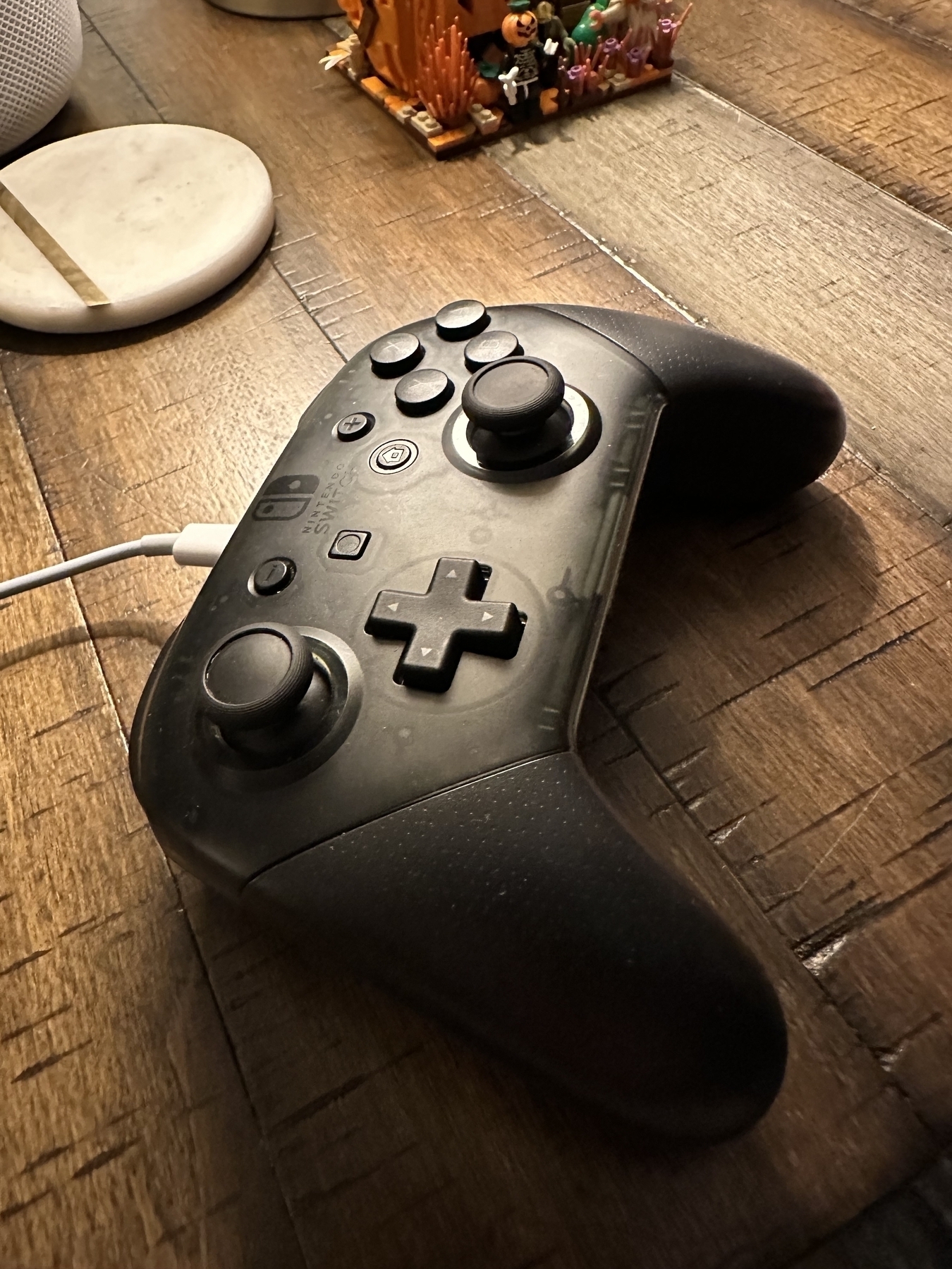 Black switch pro controller in wood table