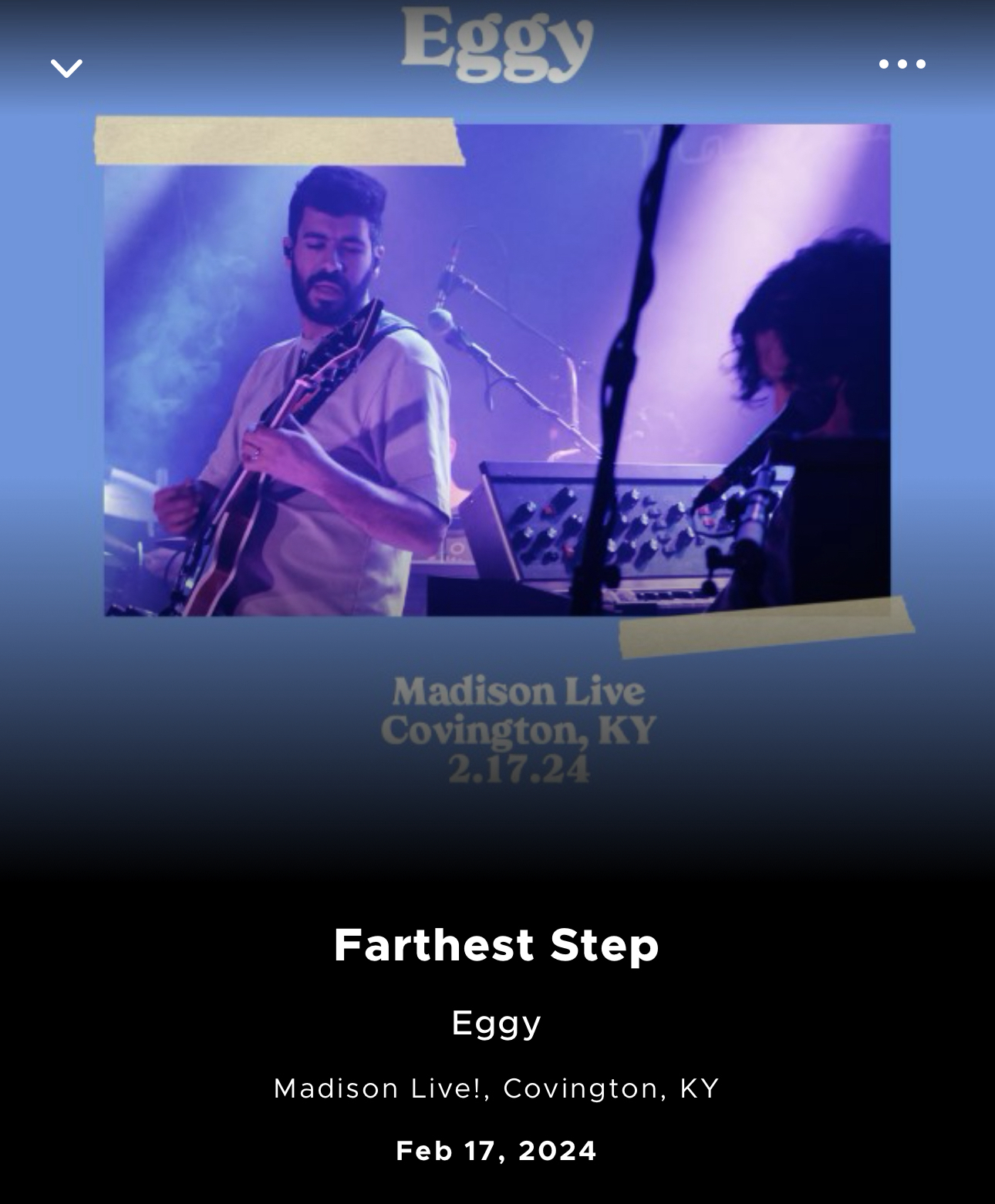 A promotional music player interface for the band Eggy, featuring an image of two musicians on stage, with one playing the guitar and the other on keyboards. Below the image, text indicates the song title “Farthest Step” by Eggy