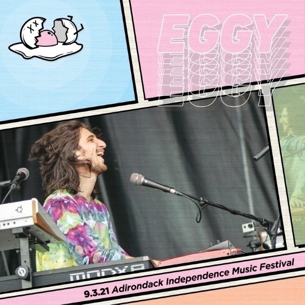 A musician with long hair and a colorful tie-dye shirt plays keyboards and sings at the Adirondack Independence Music Festival, with stylized text and graphics surrounding the photo.