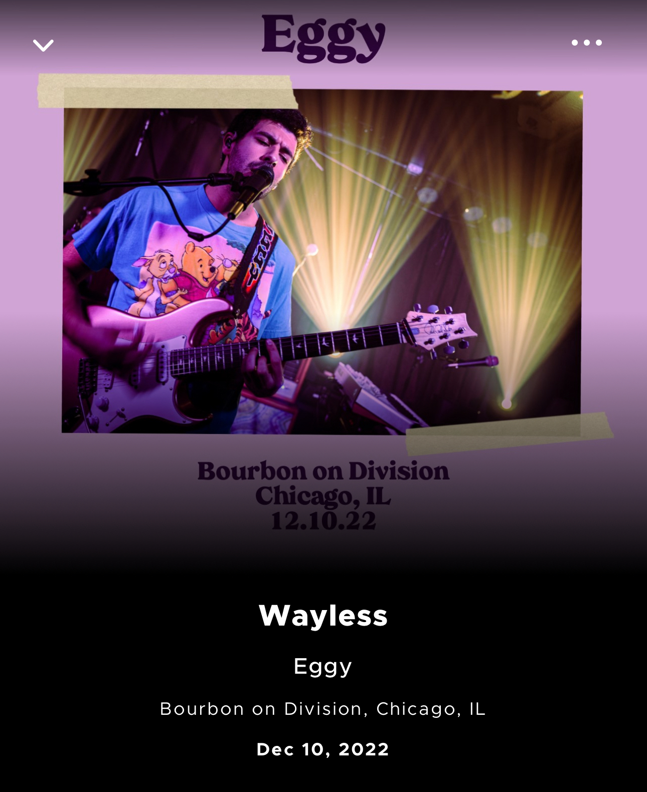 A musician playing a guitar and singing into a microphone onstage with colored stage lighting, promoting an event for the band Eggy at Bourbon on Division in Chicago, IL on December 10, 2022, with the word “Wayless” highlighted as