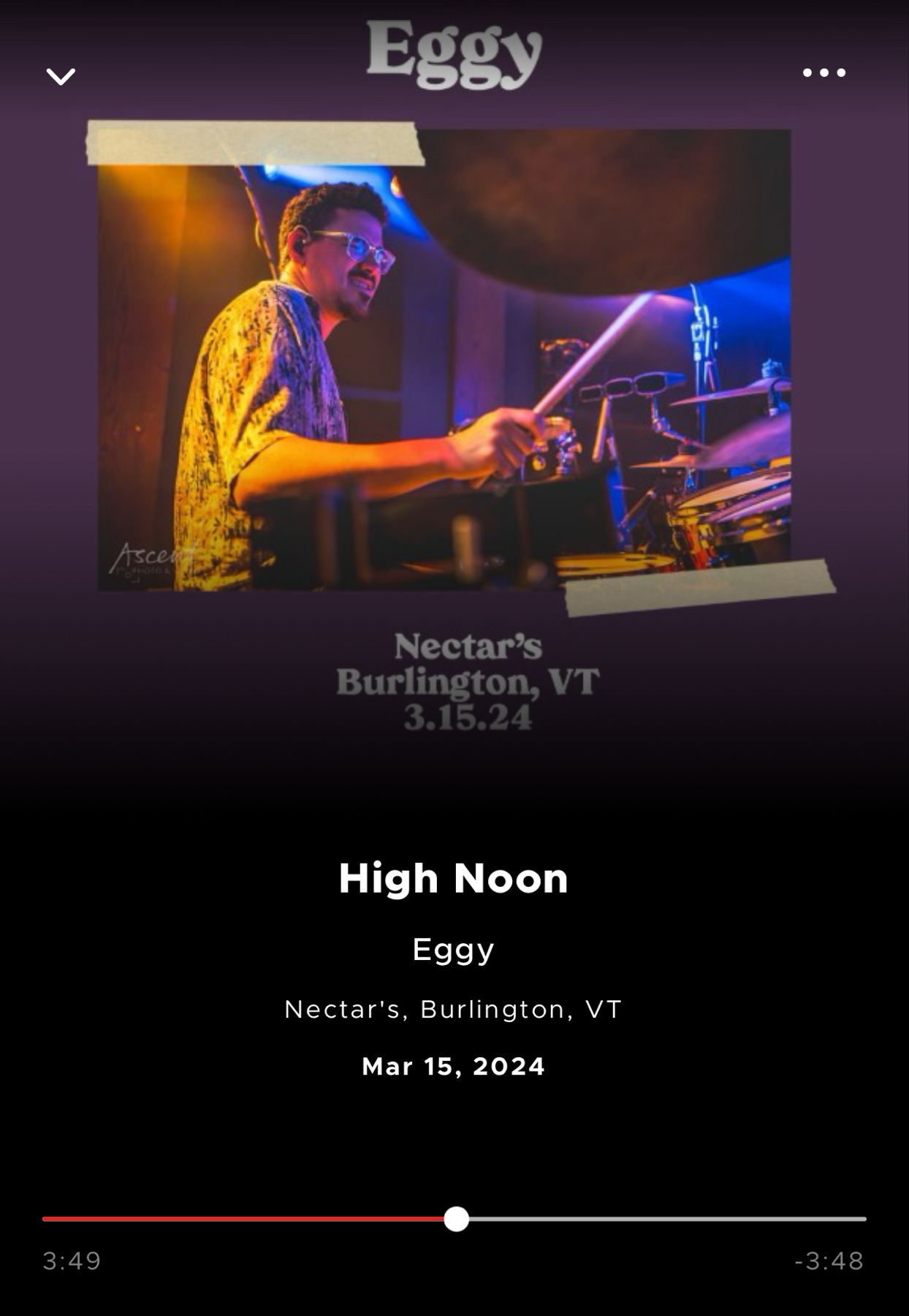 The image displays a media player with a photo of a male drummer in performance. The overlaying text reads “Eggy, High Noon, Nectar’s, Burlington, VT, Mar 15, 2024.” The playback timeline is paused