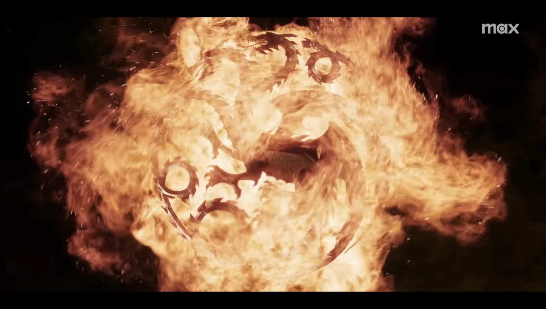 A fiery visual effect resembling a face, with elements that suggest eyes and a mouth within the flames. The word “max” appears in the top right corner, indicating branding or watermark.