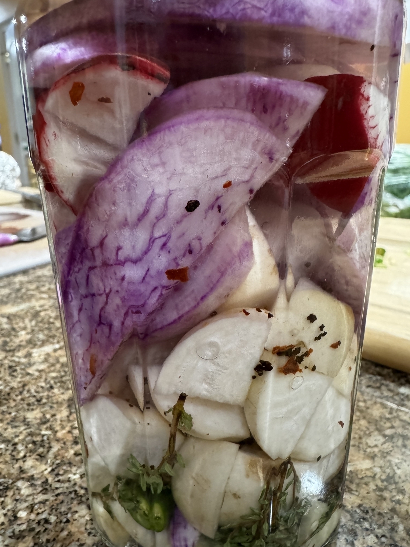 Root vegetables pickling in a mason jar. 