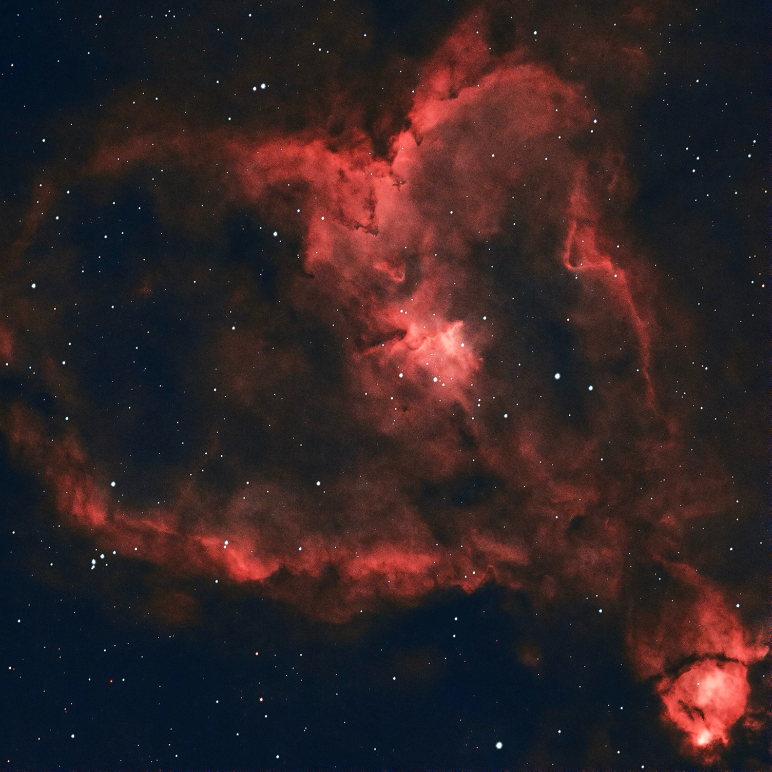 red heart shaped nebula with many stars