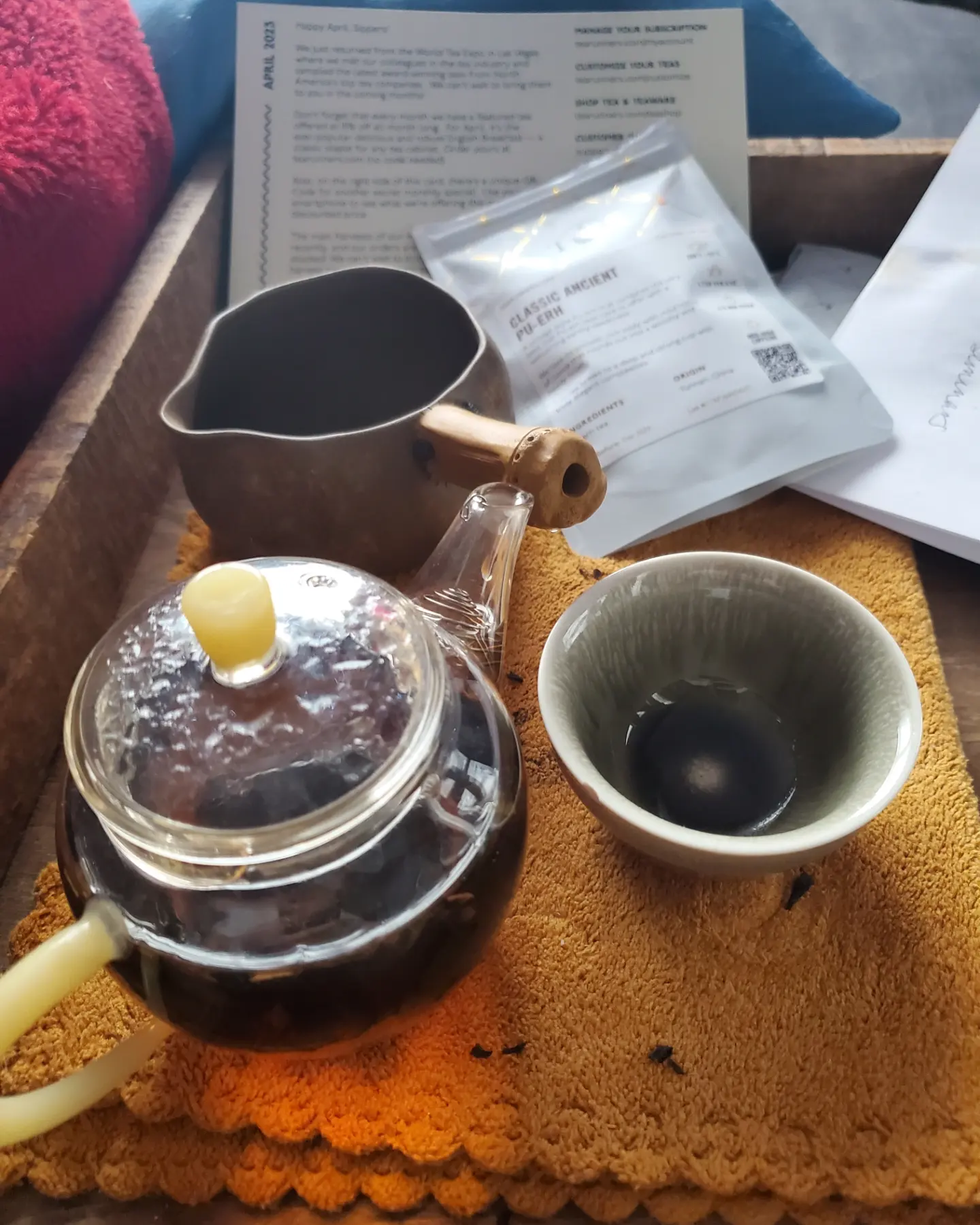 Picture of small glass teapot, pitcher, and one small porcelain tea cup.