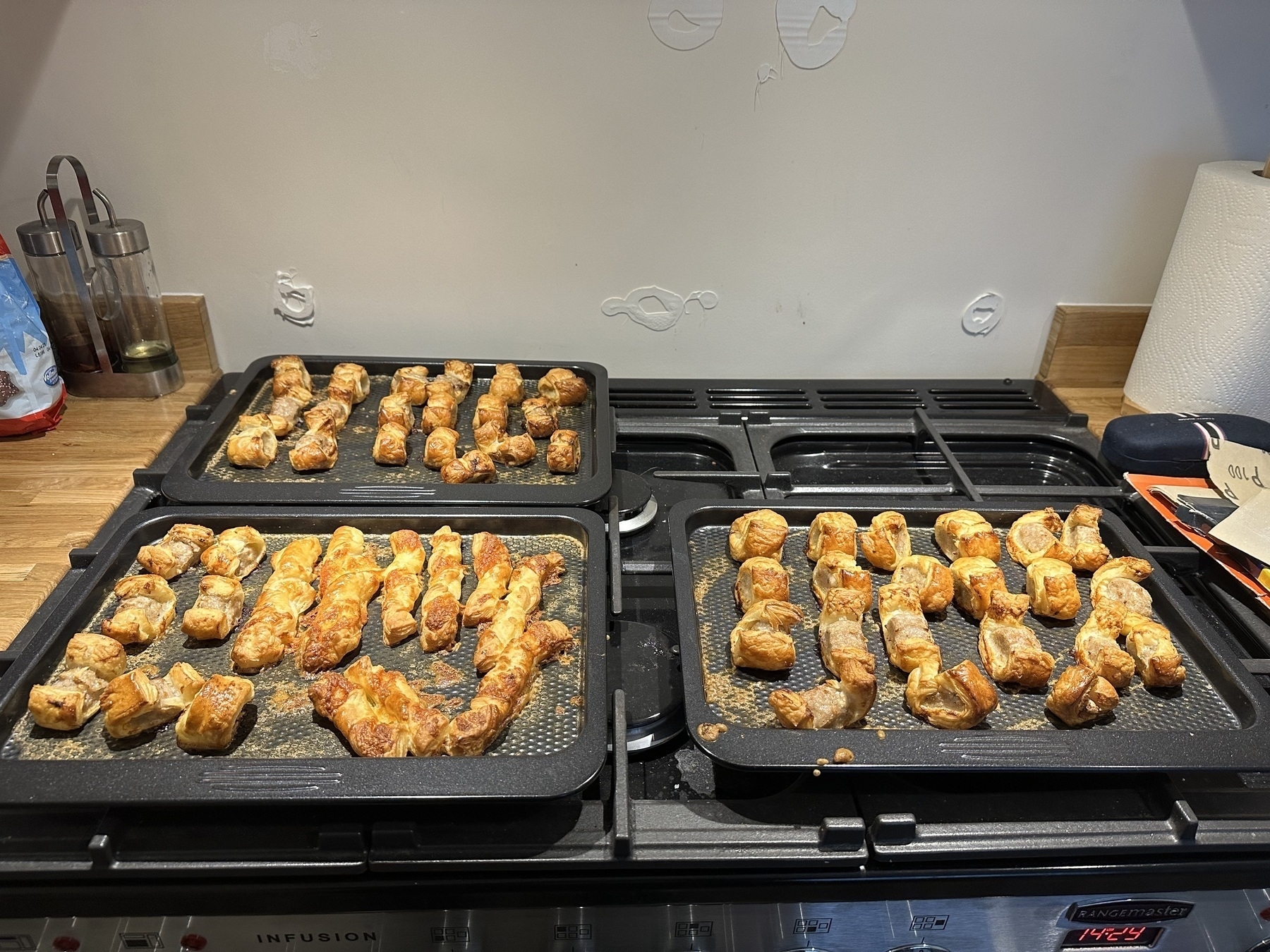 Cooked sausage rolls on baking trays