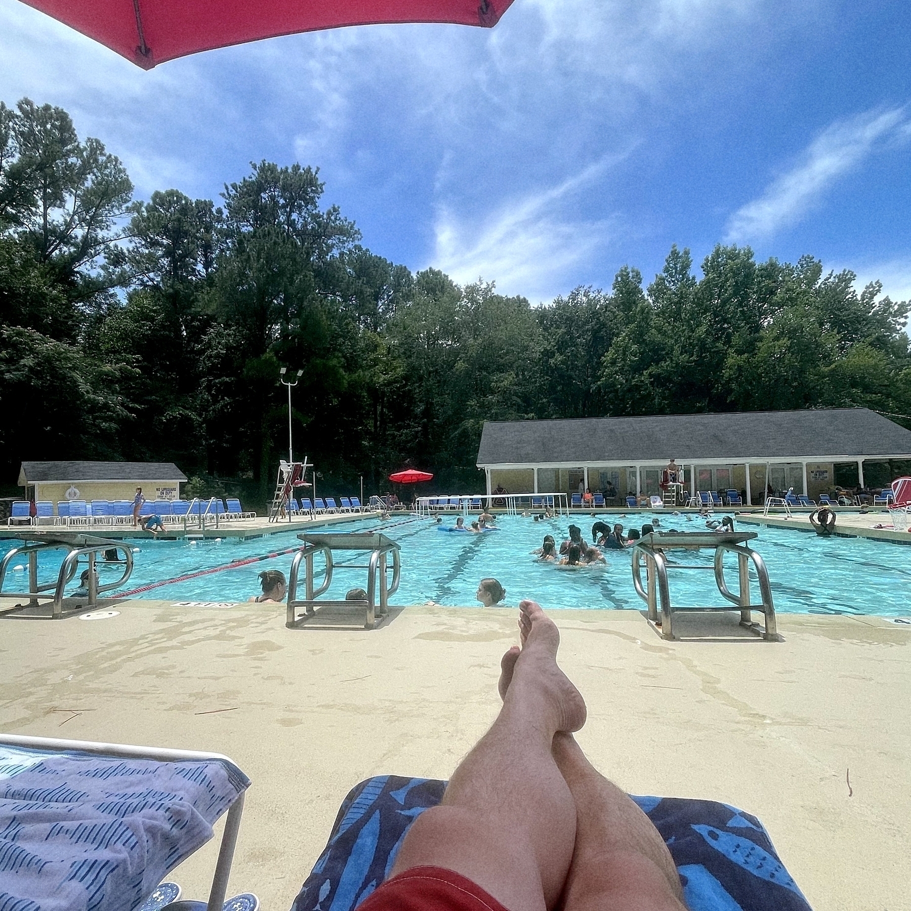 Relaxing at the pool. Feet propped up in the foreground. 