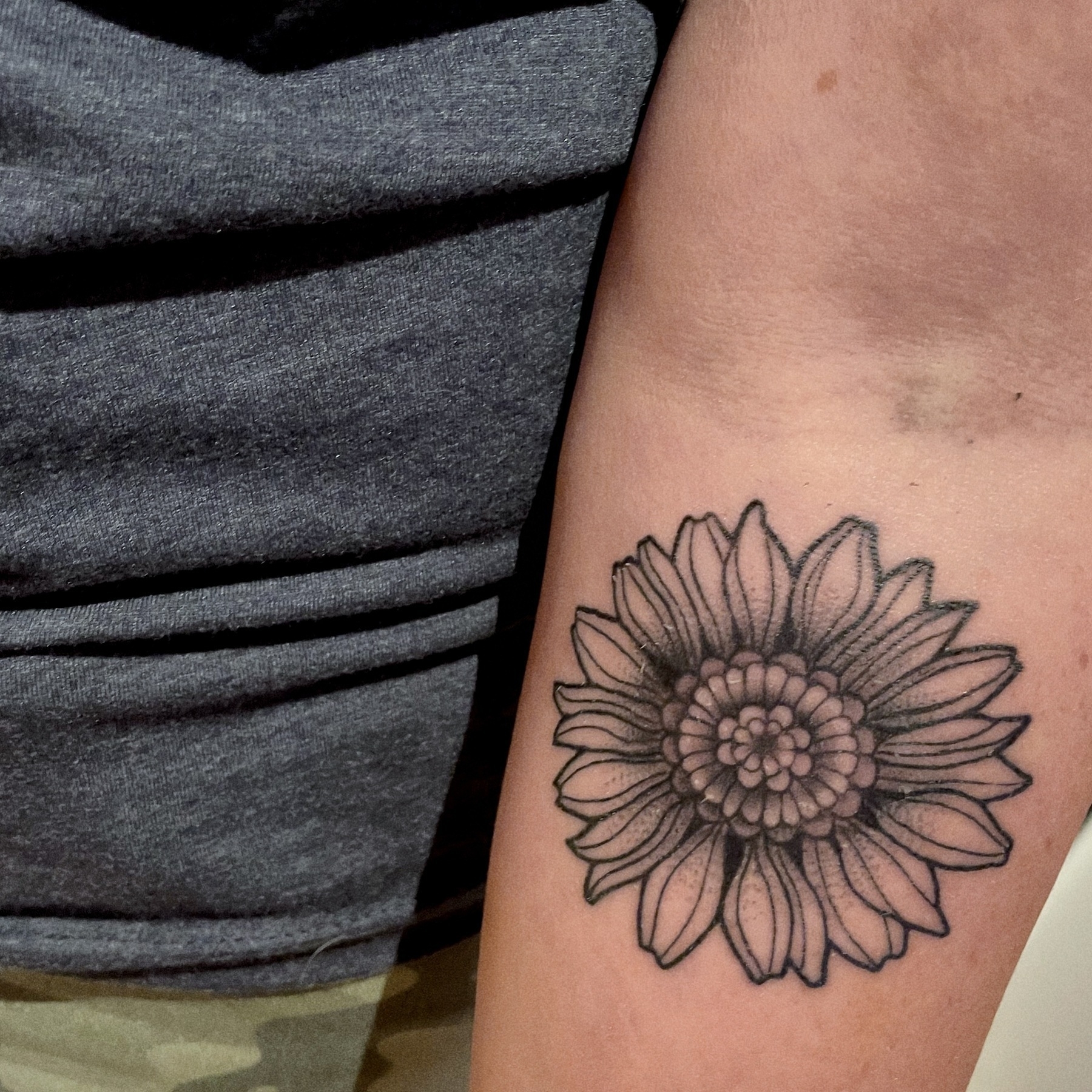 Sunflower tattoo on a woman's forearm
