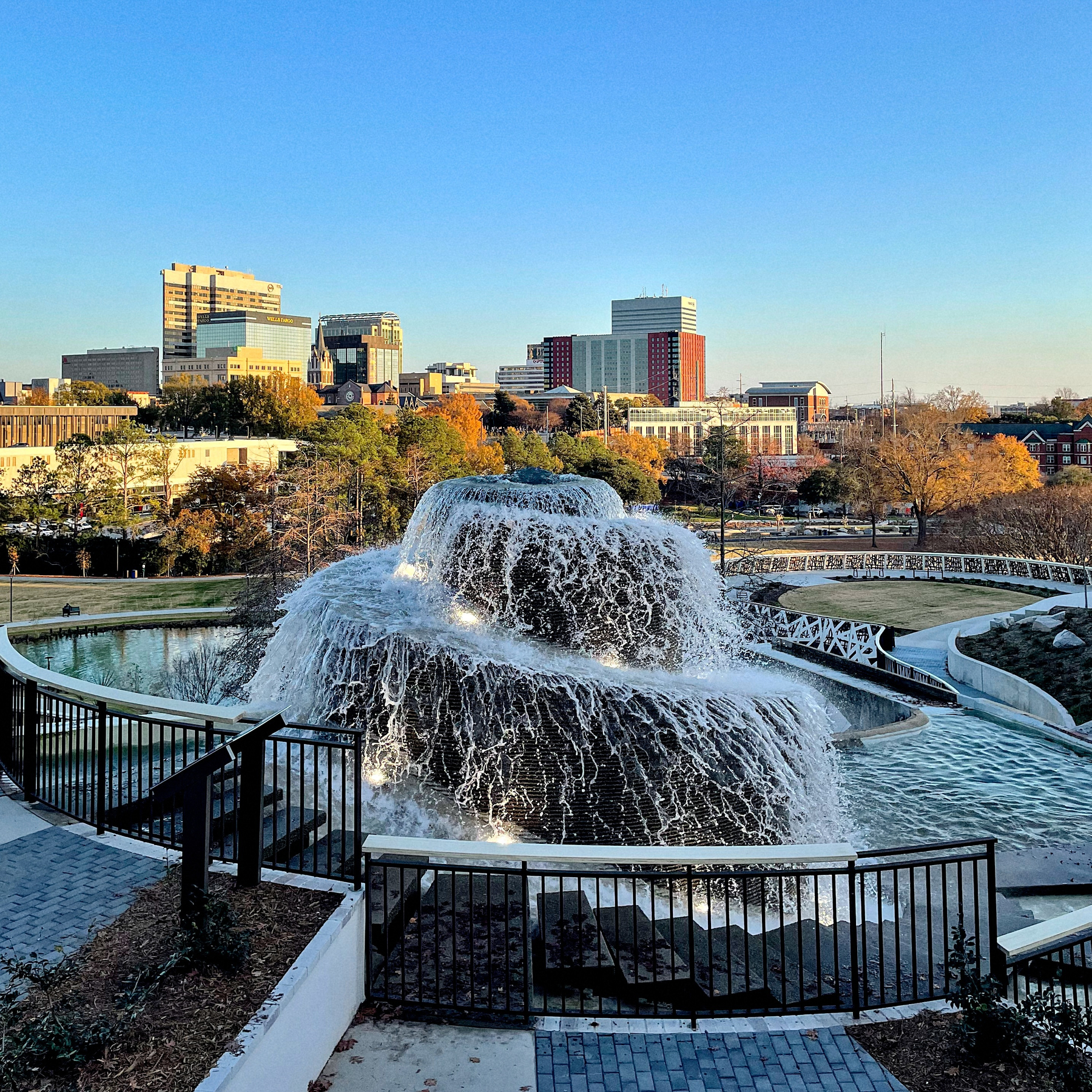 A large cascading fountain is set in Finlay Park with the Columbia, South Carolina skyline in the background.