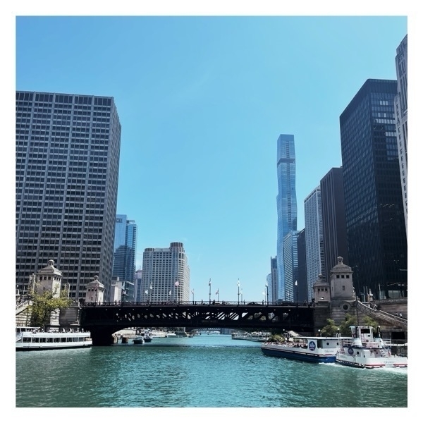 The Chicago River with a bridge over it and buildings surrounding it.