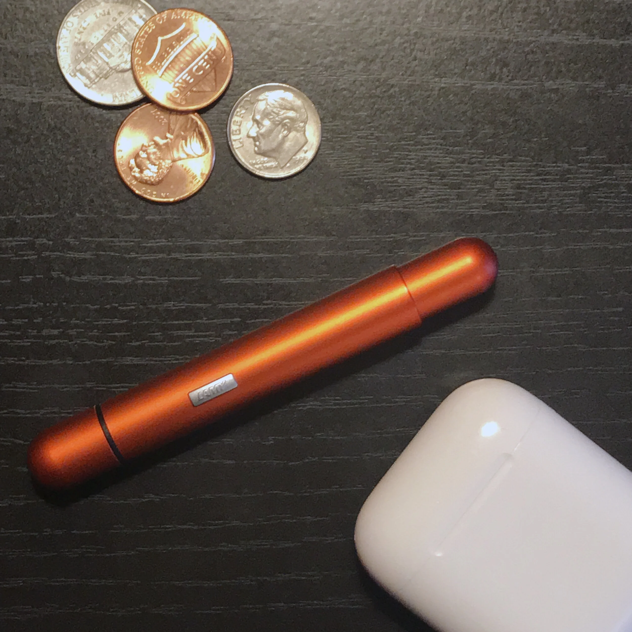 For reference: The Lamy Pico with some random change and my AirPods.