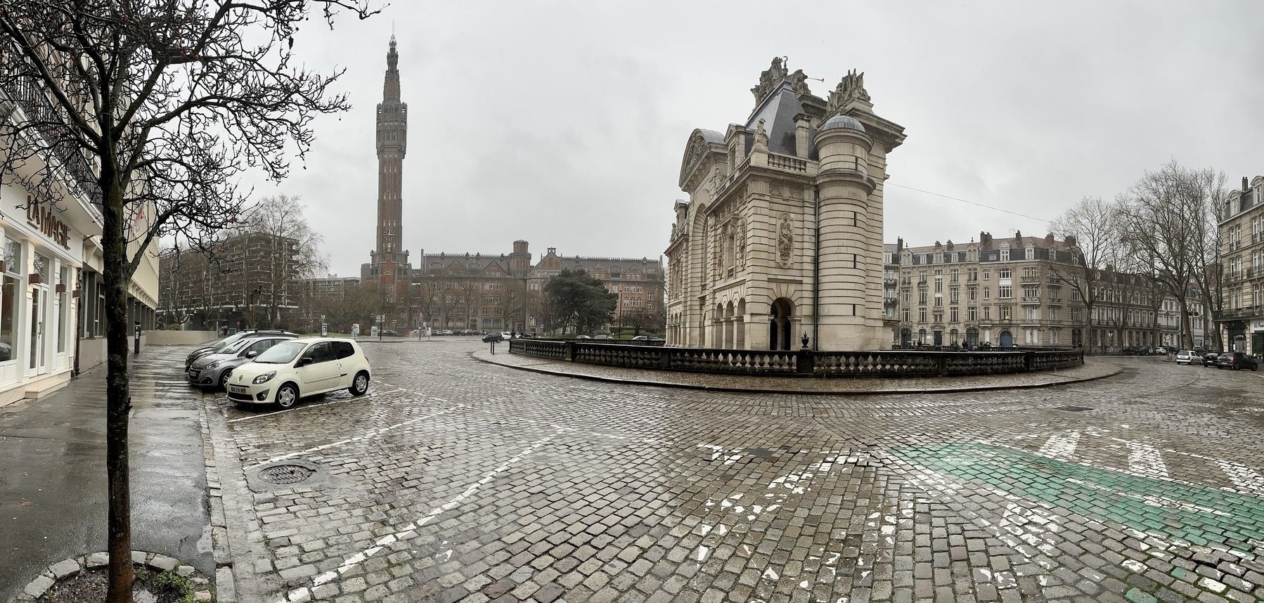 Belfry, city hall and Port de Paris in the rain