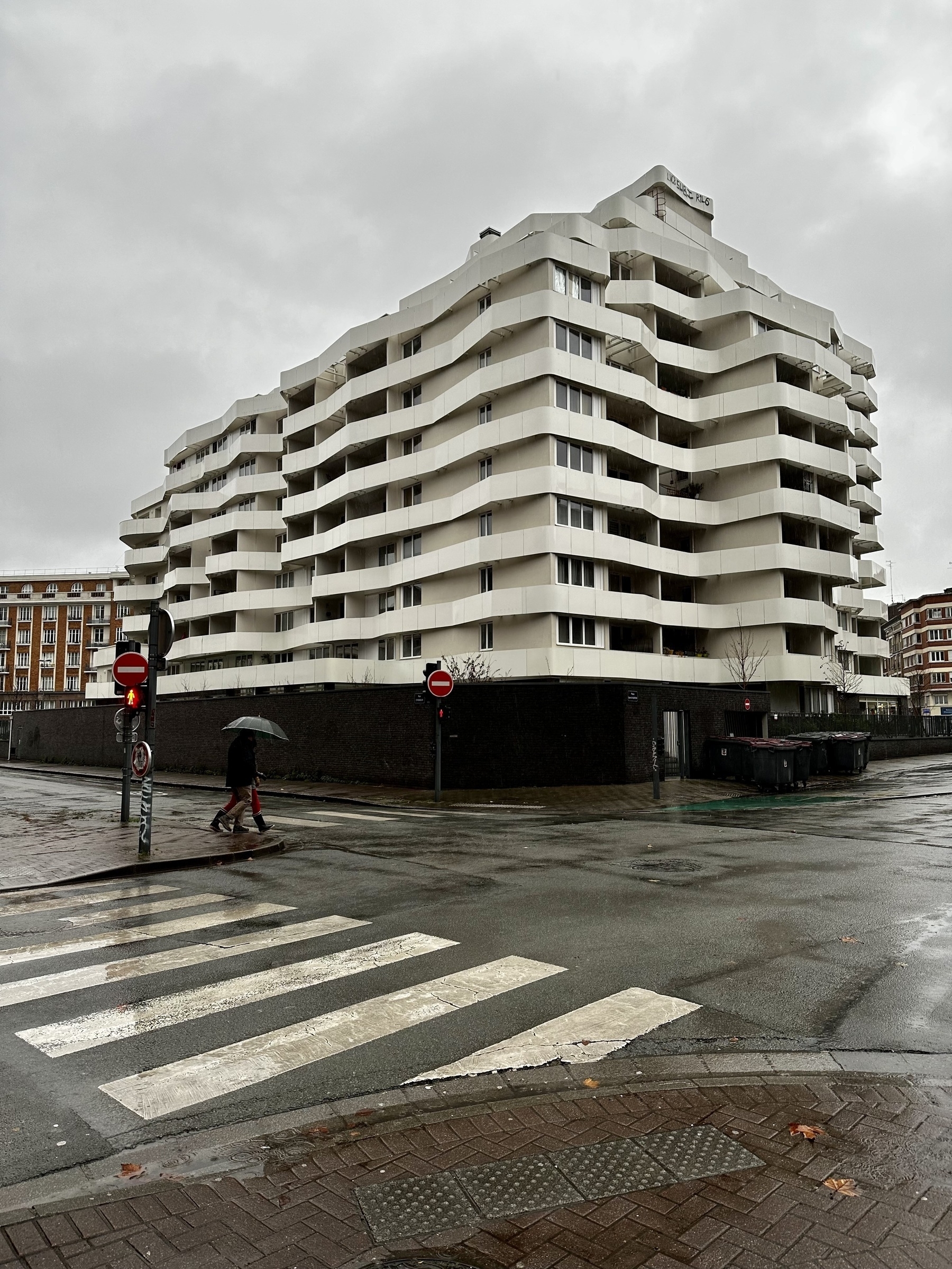 Modern, white appartement building in the rain