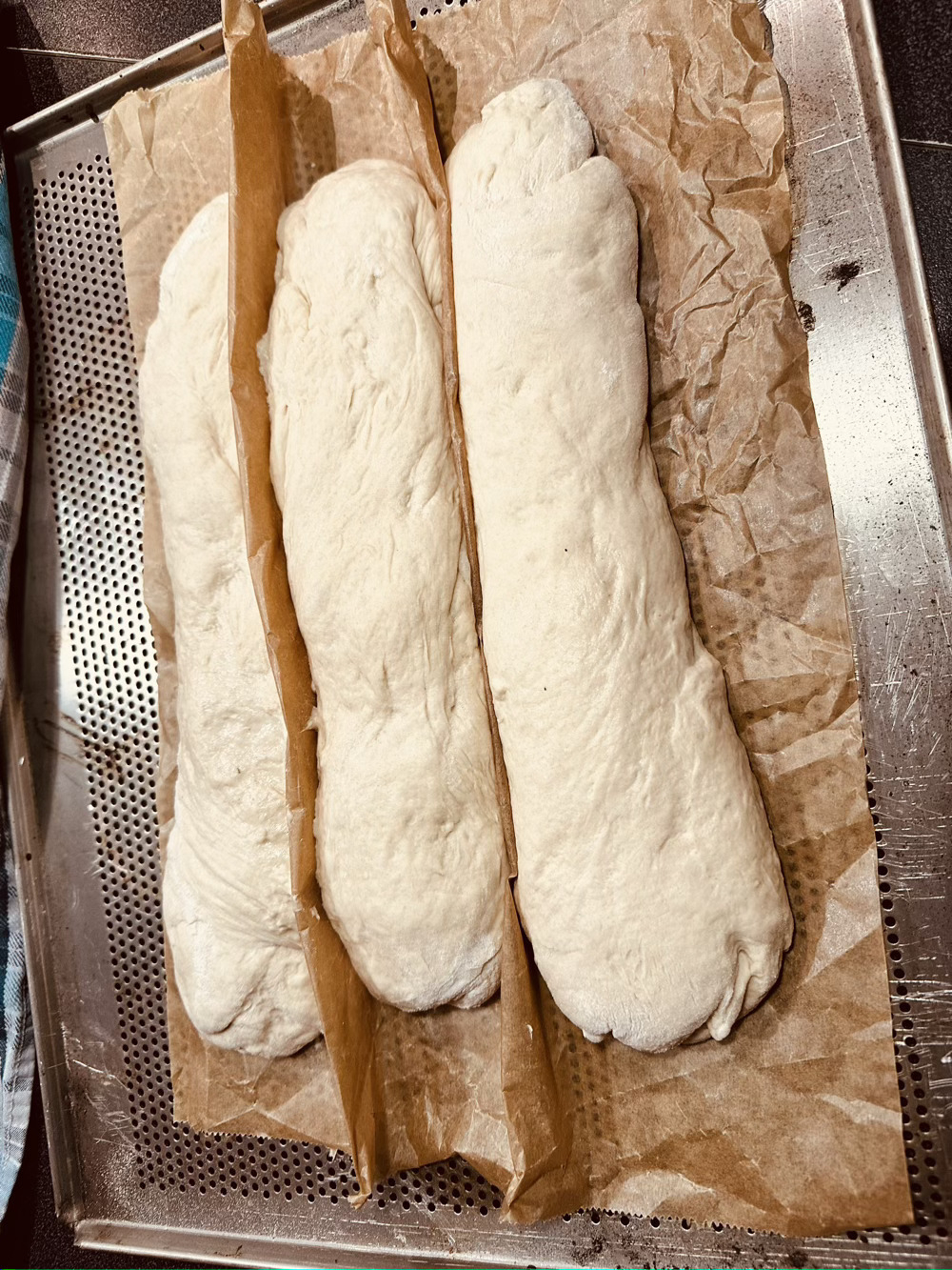 shaped baguette resting on baking parchment 