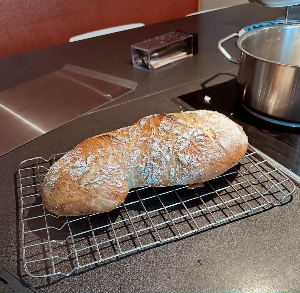 freshly baked long loaf on cooling rack 