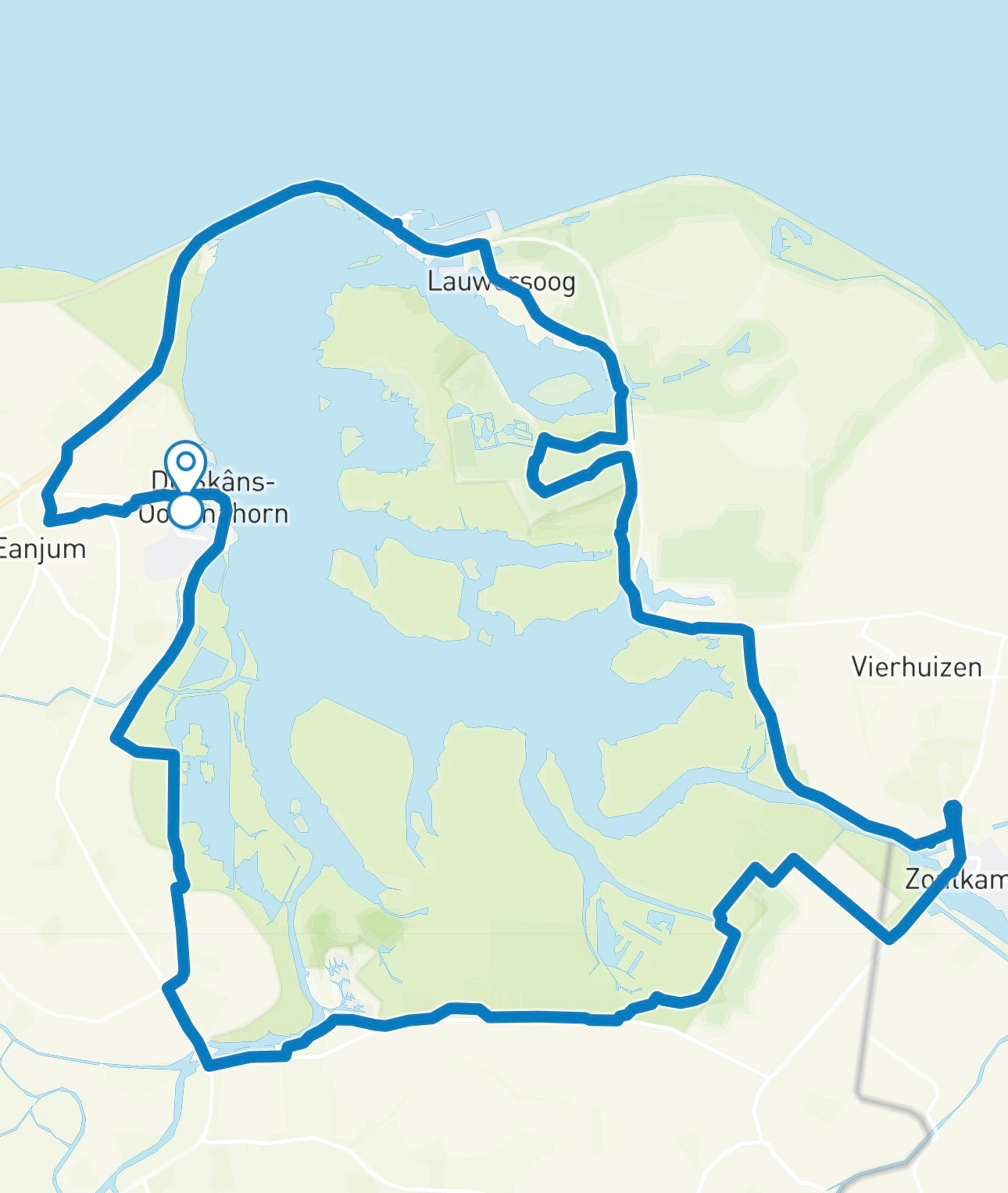 A route is outlined on a map showing a path around a body of water near towns including Lauwersoog, Zoutkamp, and Oudeschans-Ud. Horn.