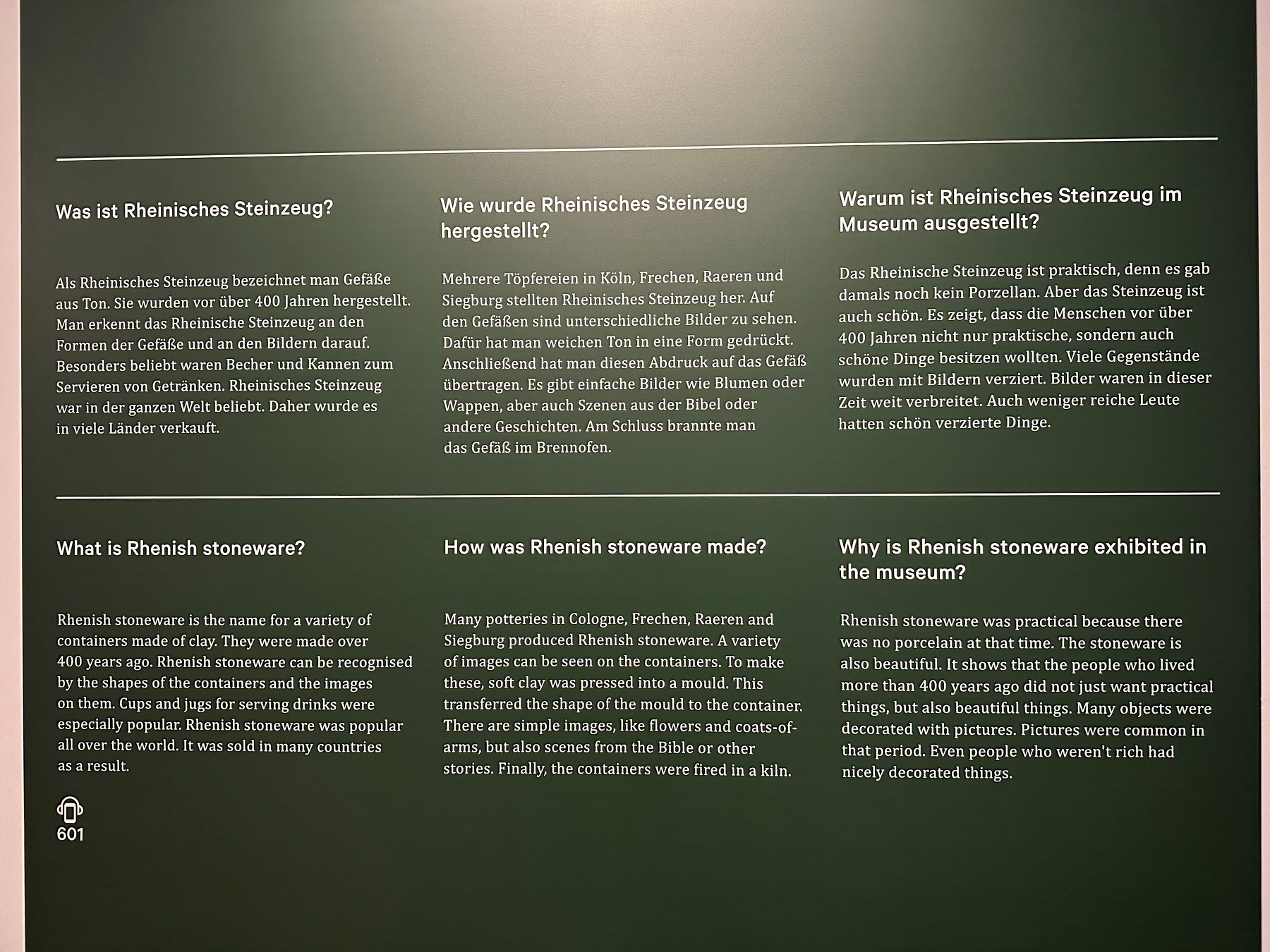 A display provides information in both German and English about Rhenish stoneware, covering its characteristics, production, and museum exhibition.