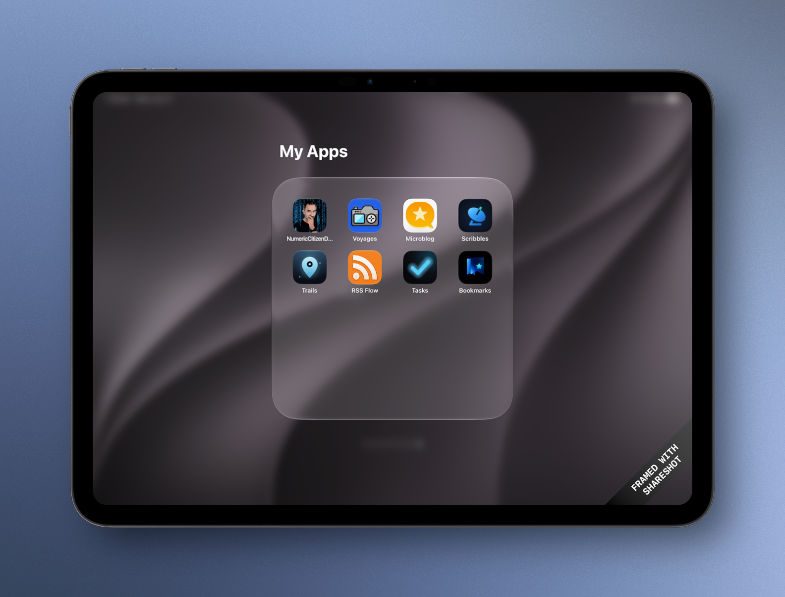 Auto-generated description: A tablet screen displays a folder labeled My Apps containing various app icons on a dark background.