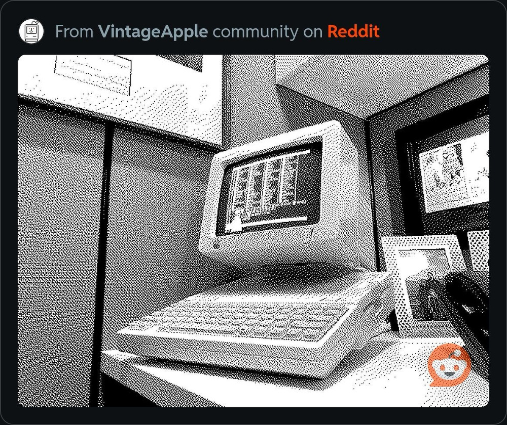 A black and white, pixelated depiction of a vintage computer setup is displayed, featuring a retro monitor and keyboard.