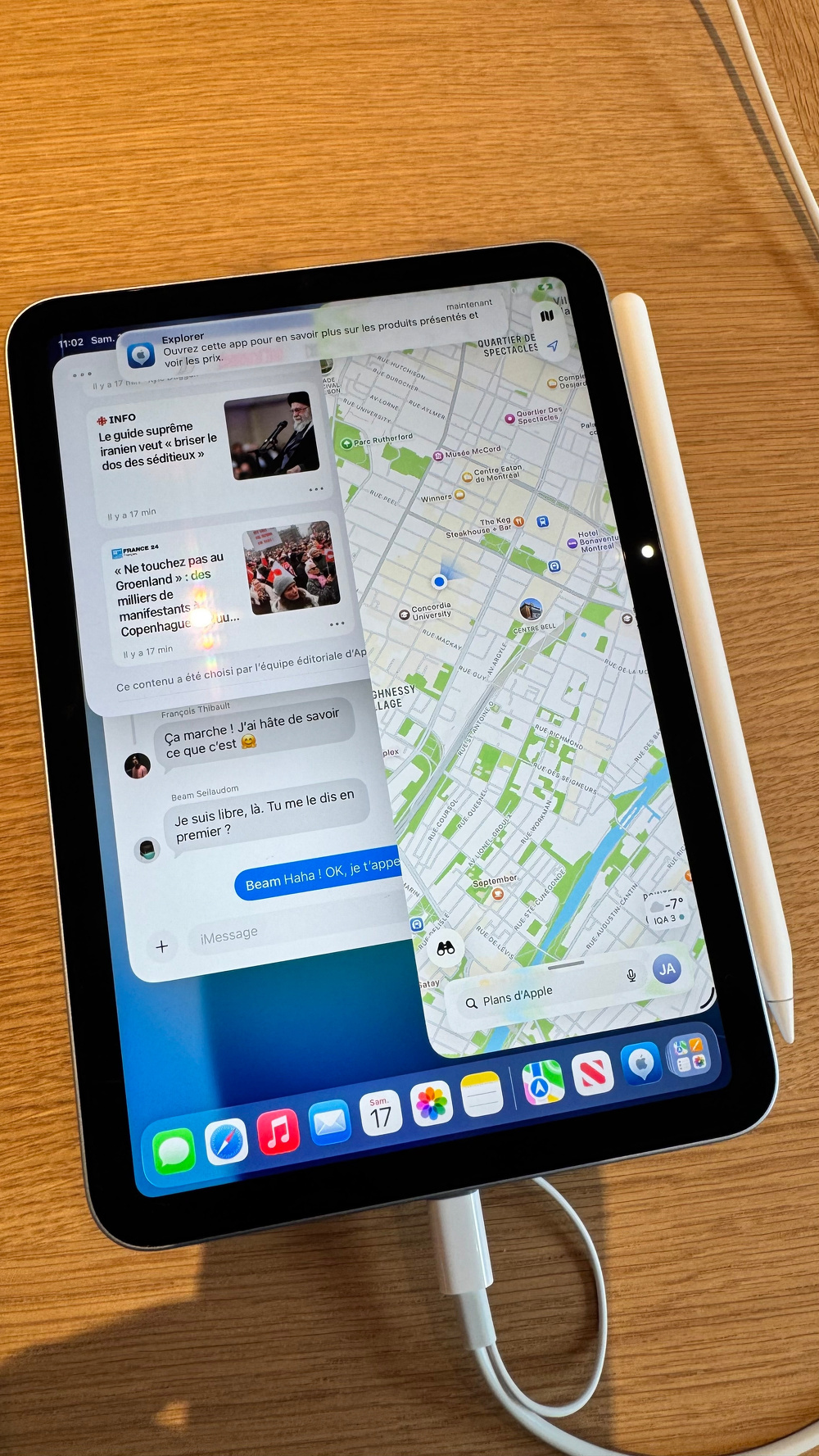 A tablet displaying a split screen with a messaging app on the left and a map on the right, accompanied by a stylus placed on the side.