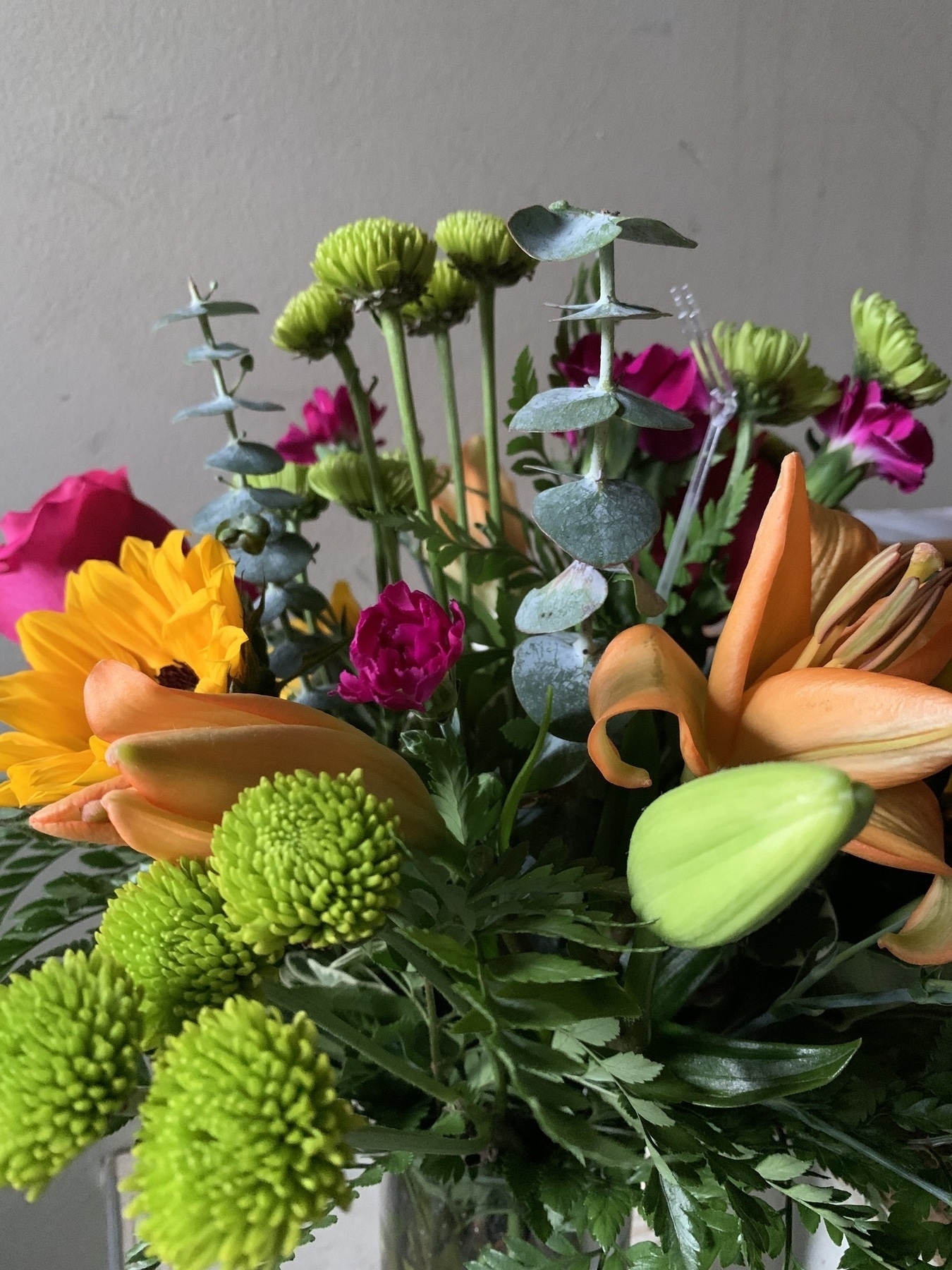 A bouquet of assorted flowers, including at least one sunflower, a rose, a few lilies and several other blooms to be named later, as delivered Tuesday, May 16, 2023 to a certain household somewhere on the Eastern Seaboard.