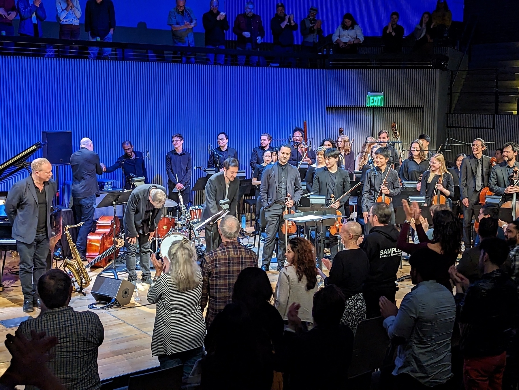 A full orchestra with conductor join SFJazz musical director Chris Potter take their bows before an audience after performing Potter's new work "Generations" Friday, April 21, 2023 in San Francisco, California 