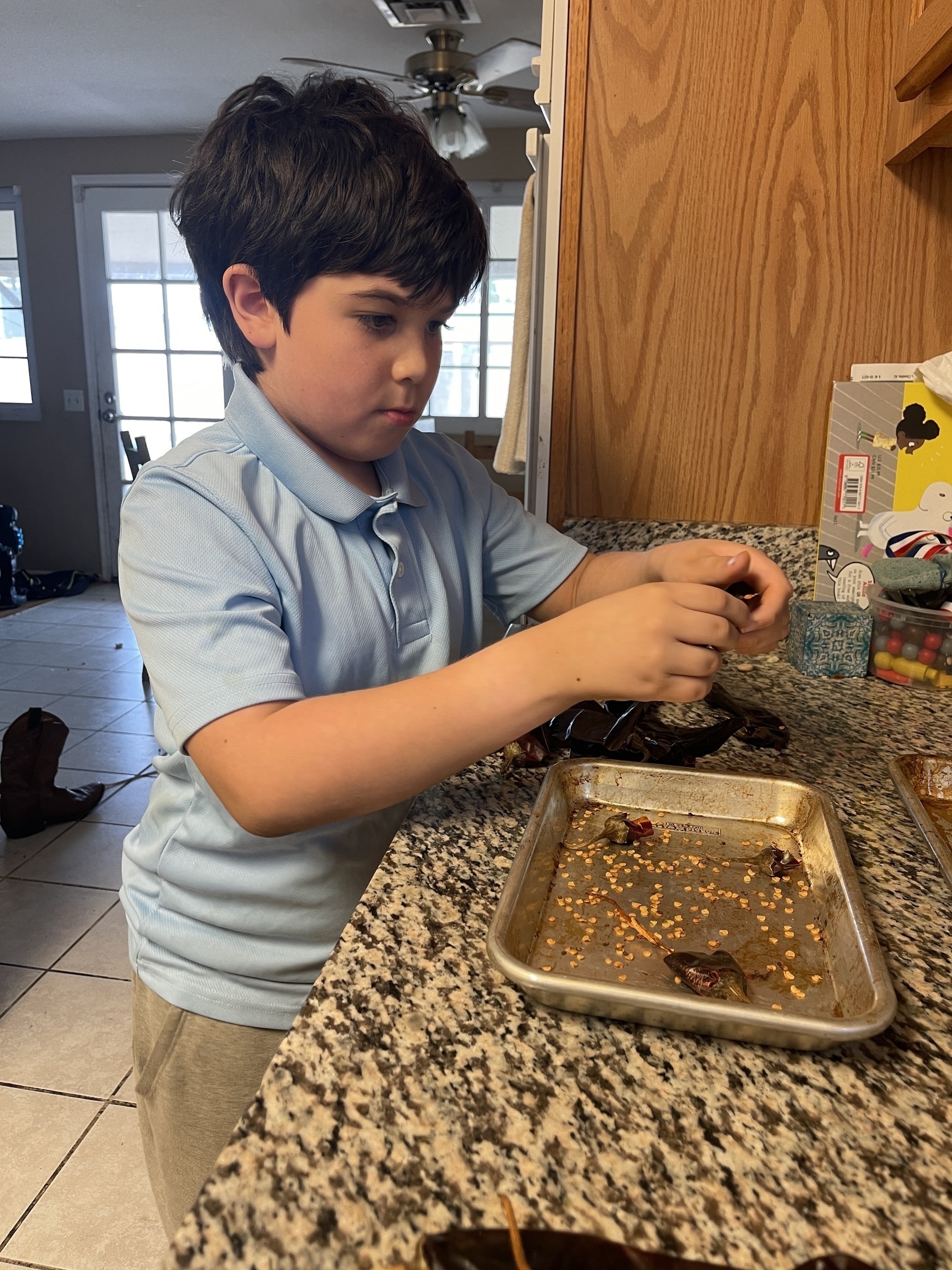 Young boy de-seeding guajillo chiles