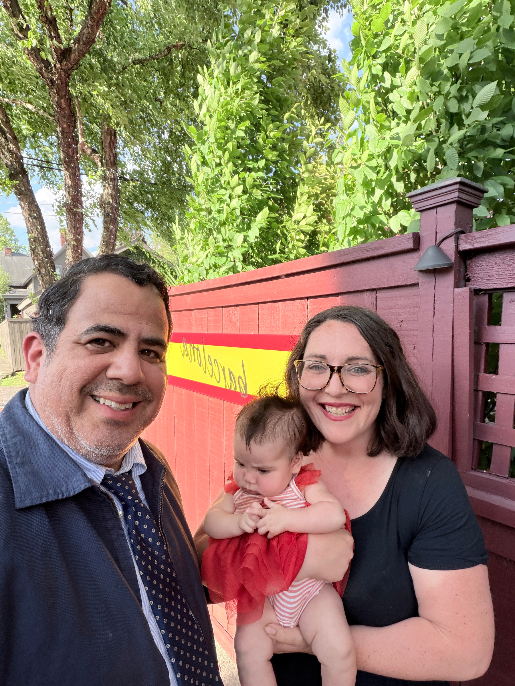 selfie of a couple with their newborn