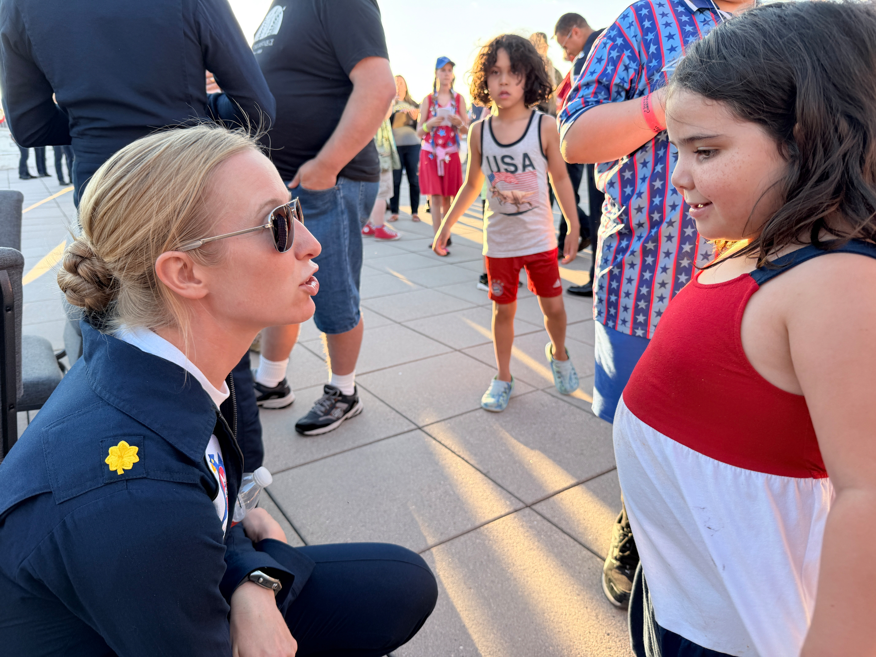 Pilot with USAF Thunderbirds talks with young girl